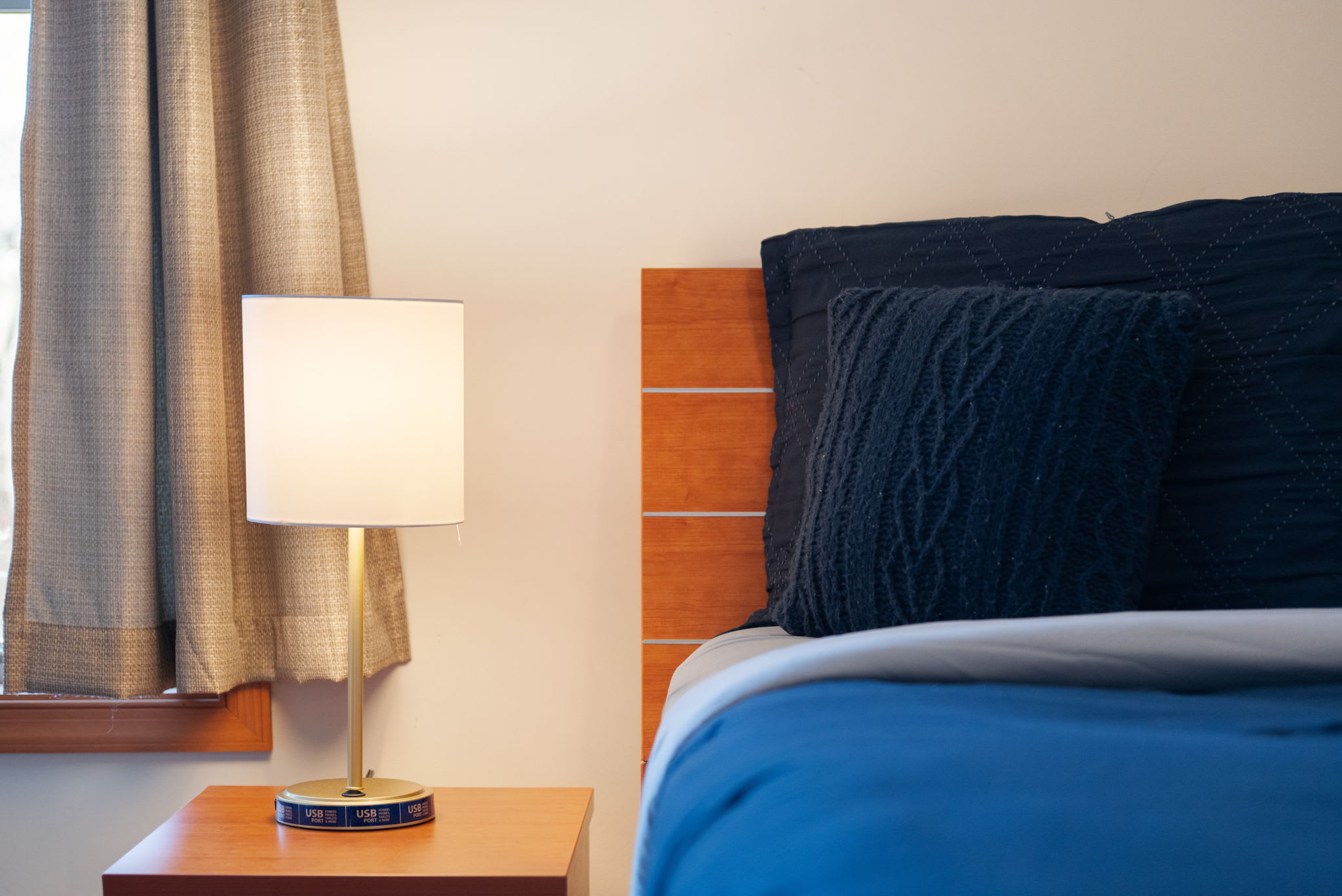 A bedside lamp sets the mood for peaceful evenings in the master suite