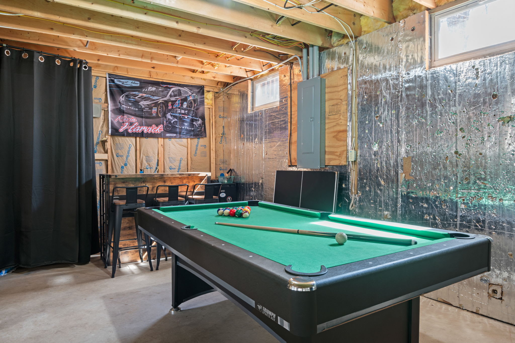 Rack up a game of pool in the inviting wood-paneled game room with ambient lighting
