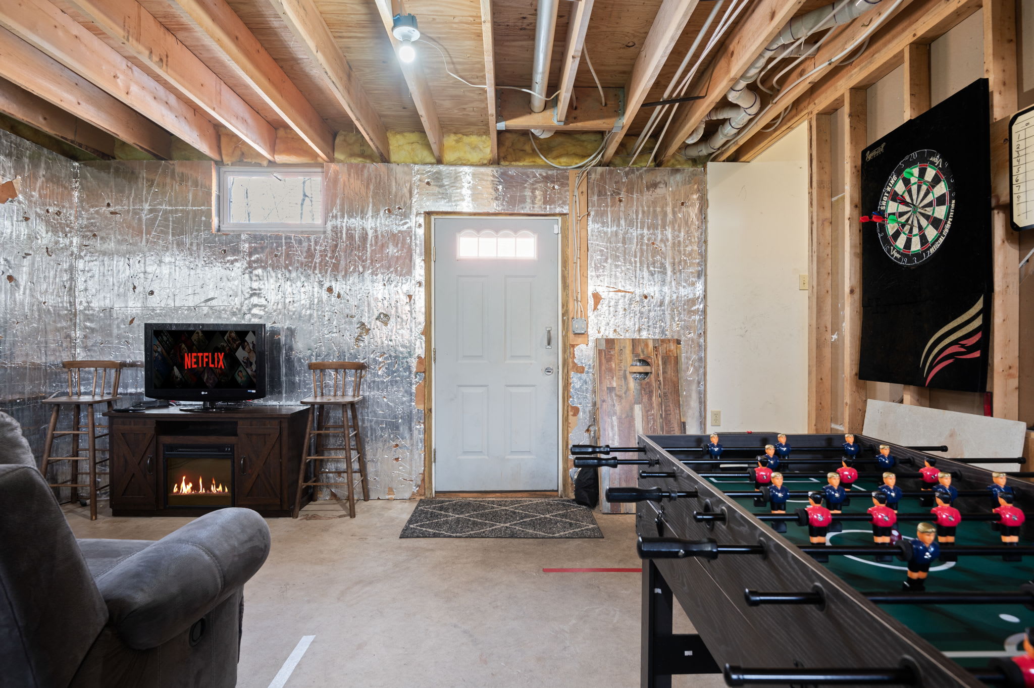 Gather around the stone fireplace in the cozy game room with foosball and darts