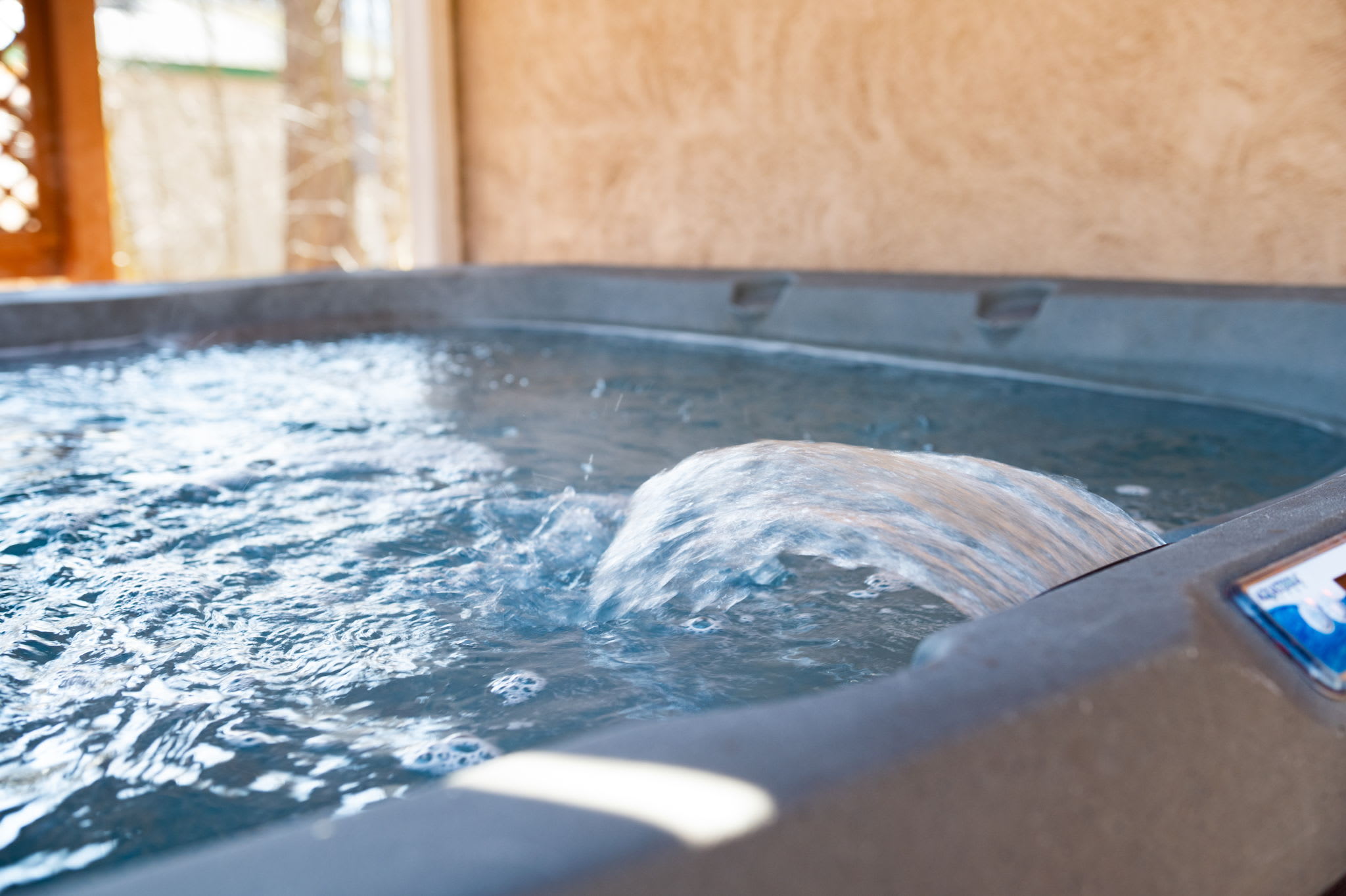 Bubble away stress in the private hot tub with soothing jets and mountain views