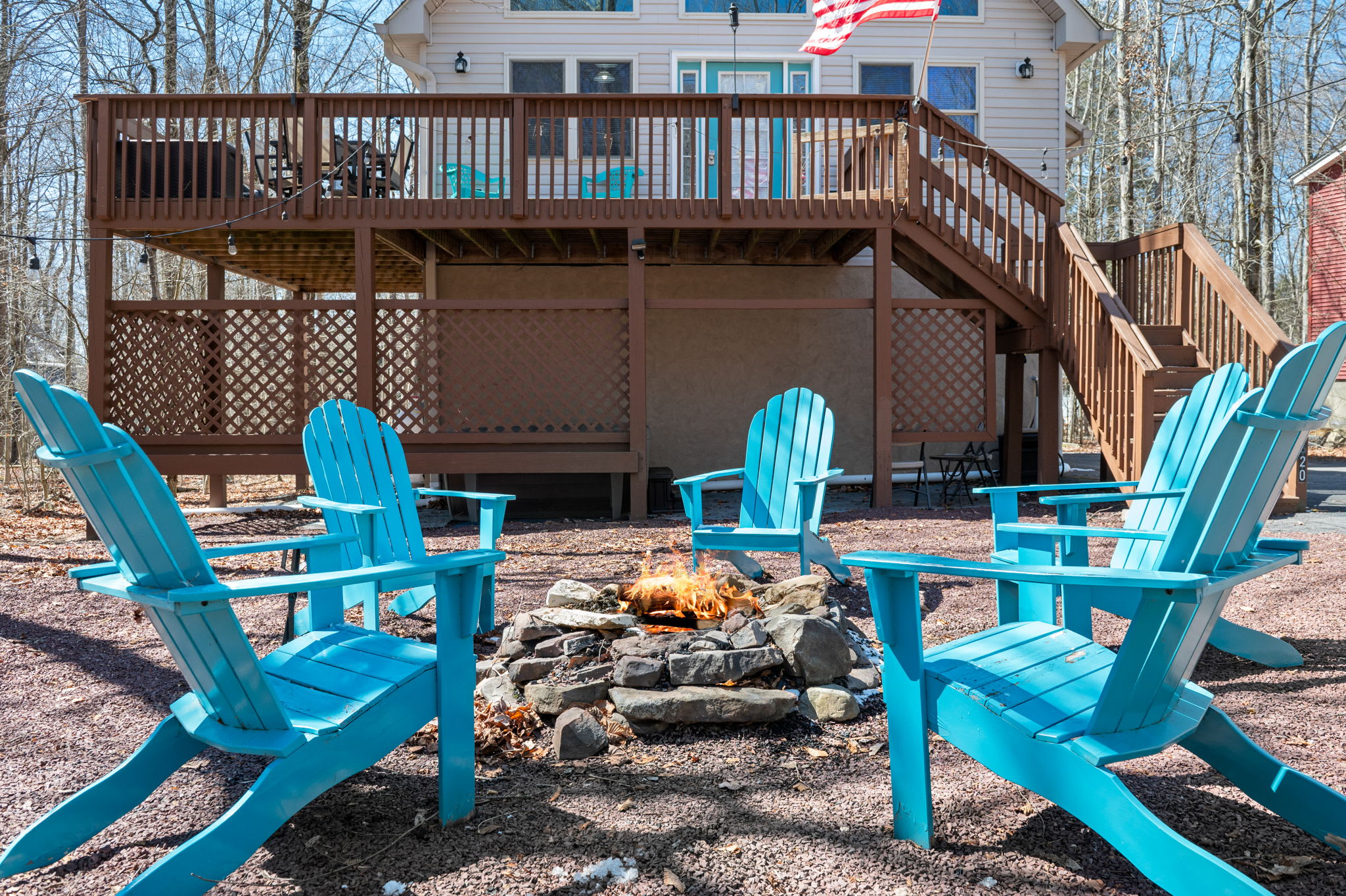 Cozy Adirondack chairs circle the fire pit for memorable evenings under the stars