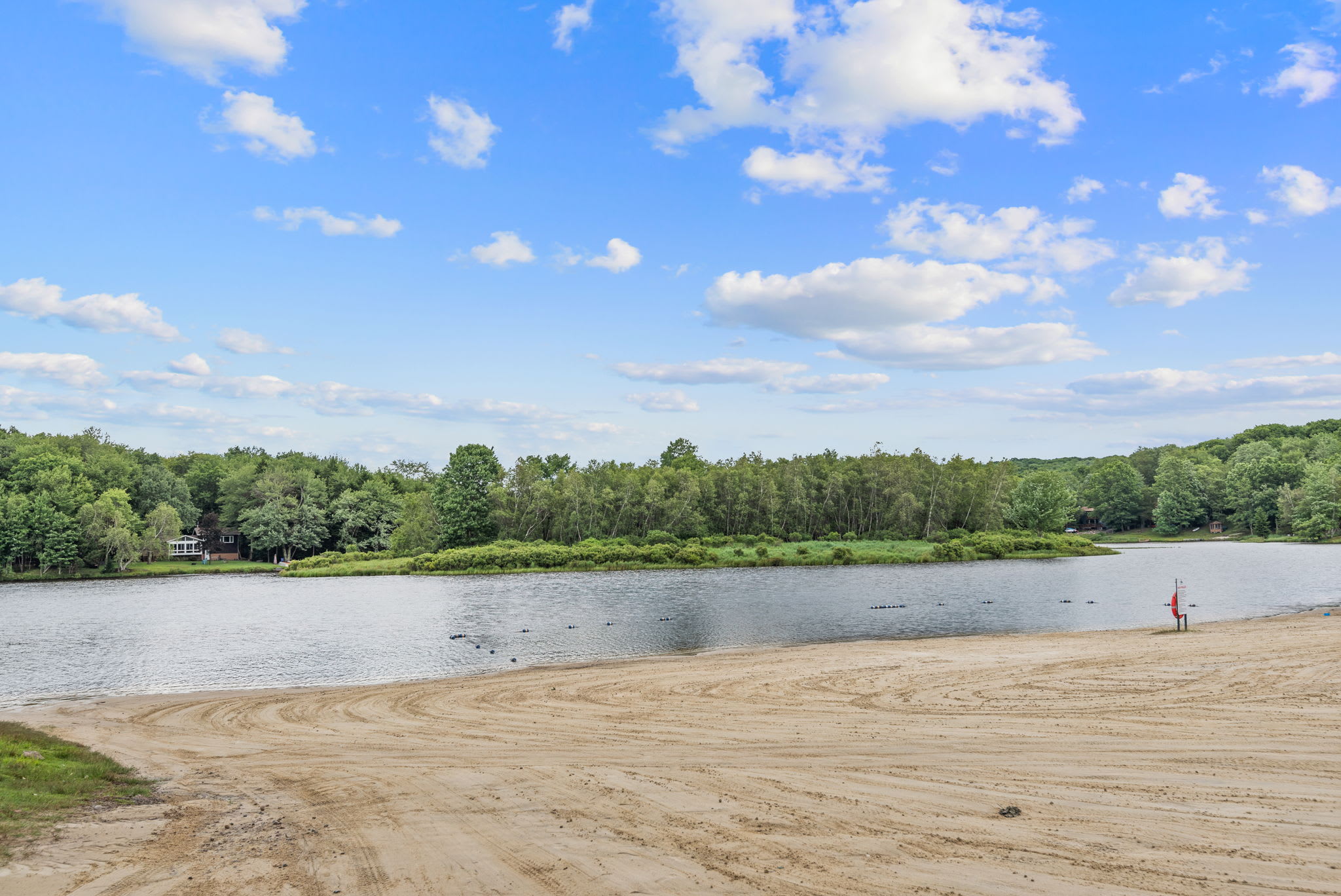 Build sandcastles and splash in the water at the lakefront beach within the community