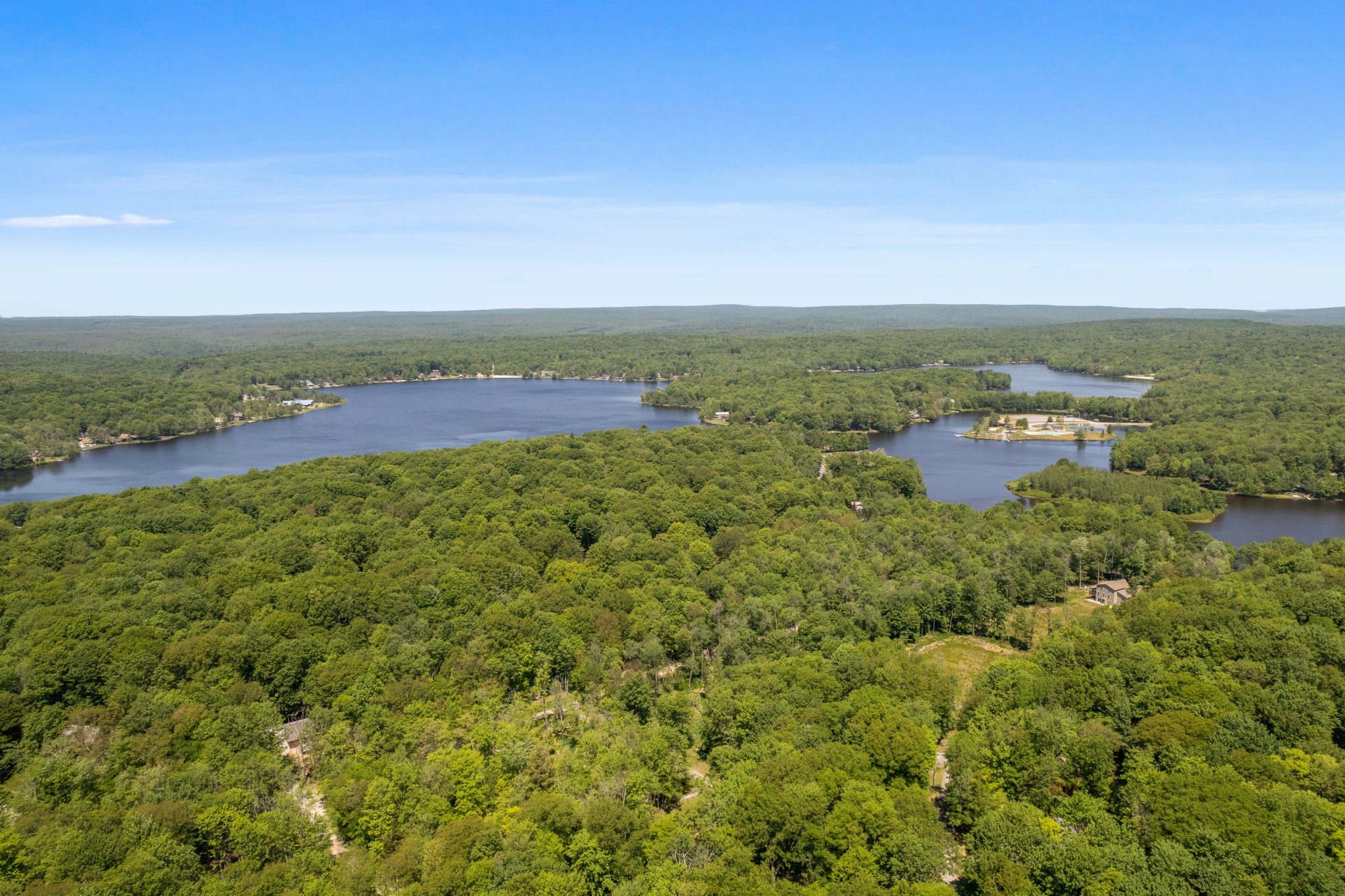 Aerial view of scenic Arrowhead Lake with lush forests and community amenities