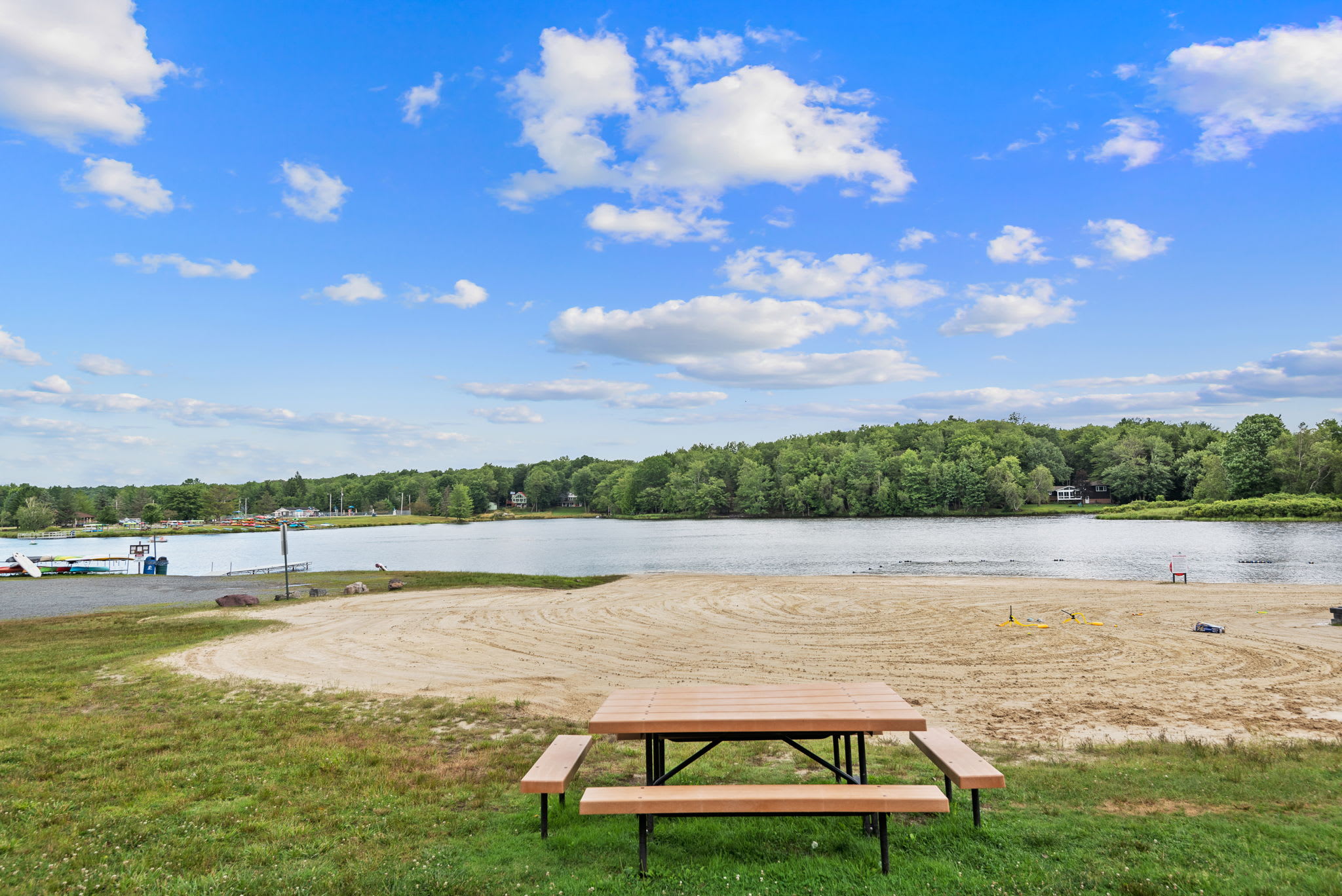 Enjoy a lakeside picnic at the community beach area with scenic water views