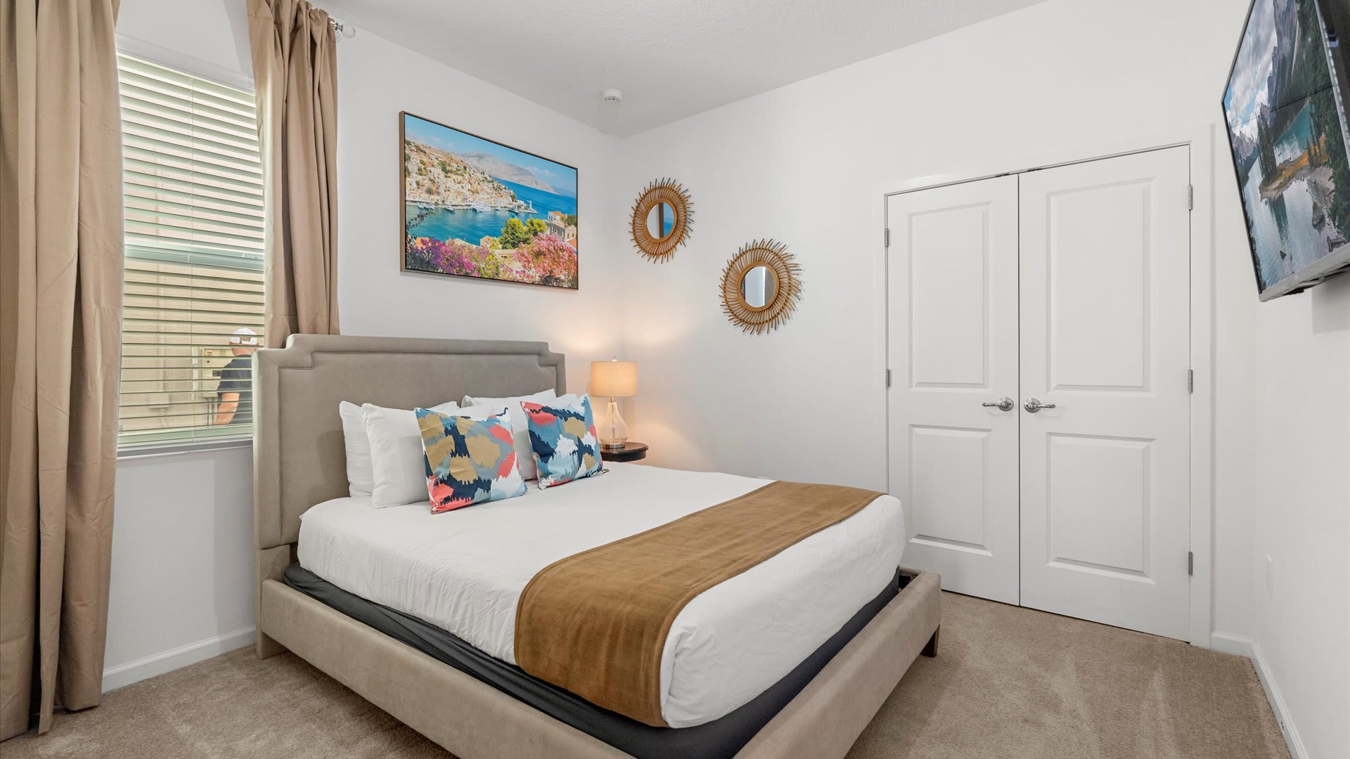 Comfortable Bedroom Featuring A Sleek Bed Frame And Wall-Mounted Smart TV