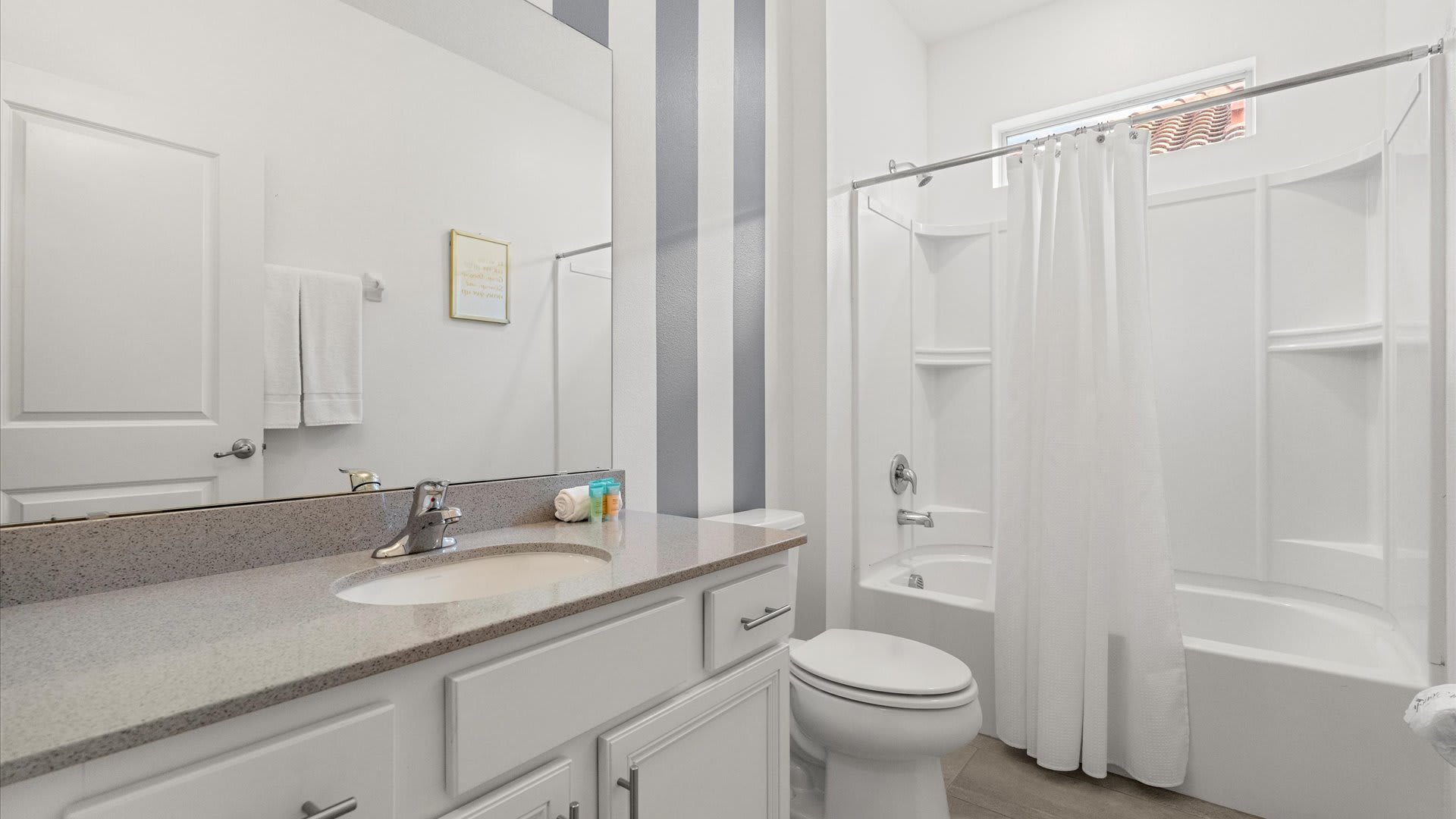 Full bathroom with combined bathtub and shower