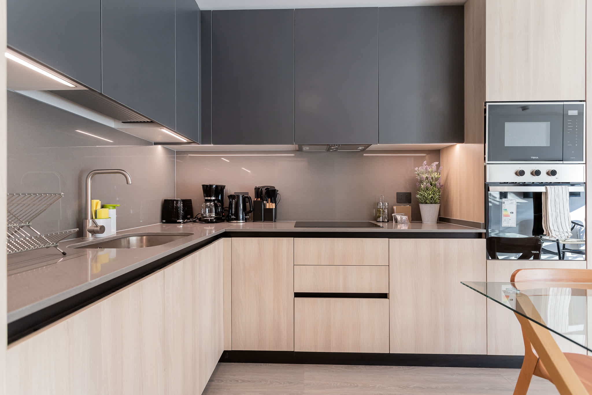 Experience culinary delights in this modern kitchen, featuring sleek cabinetry and top-notch appliances for your cooking adventures.