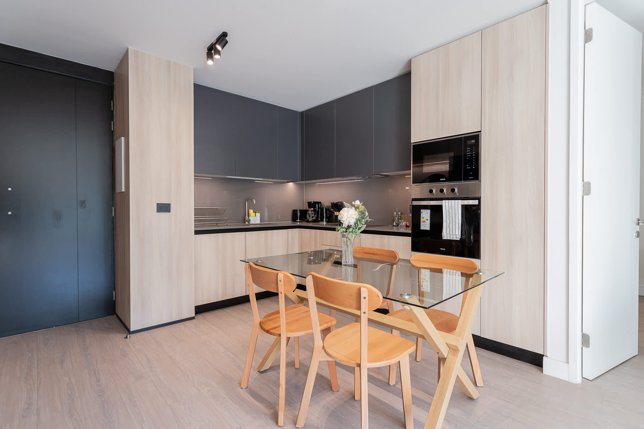 Experience modern living in this stylish kitchen, featuring a sleek design and a cozy dining area perfect for meals and gatherings.