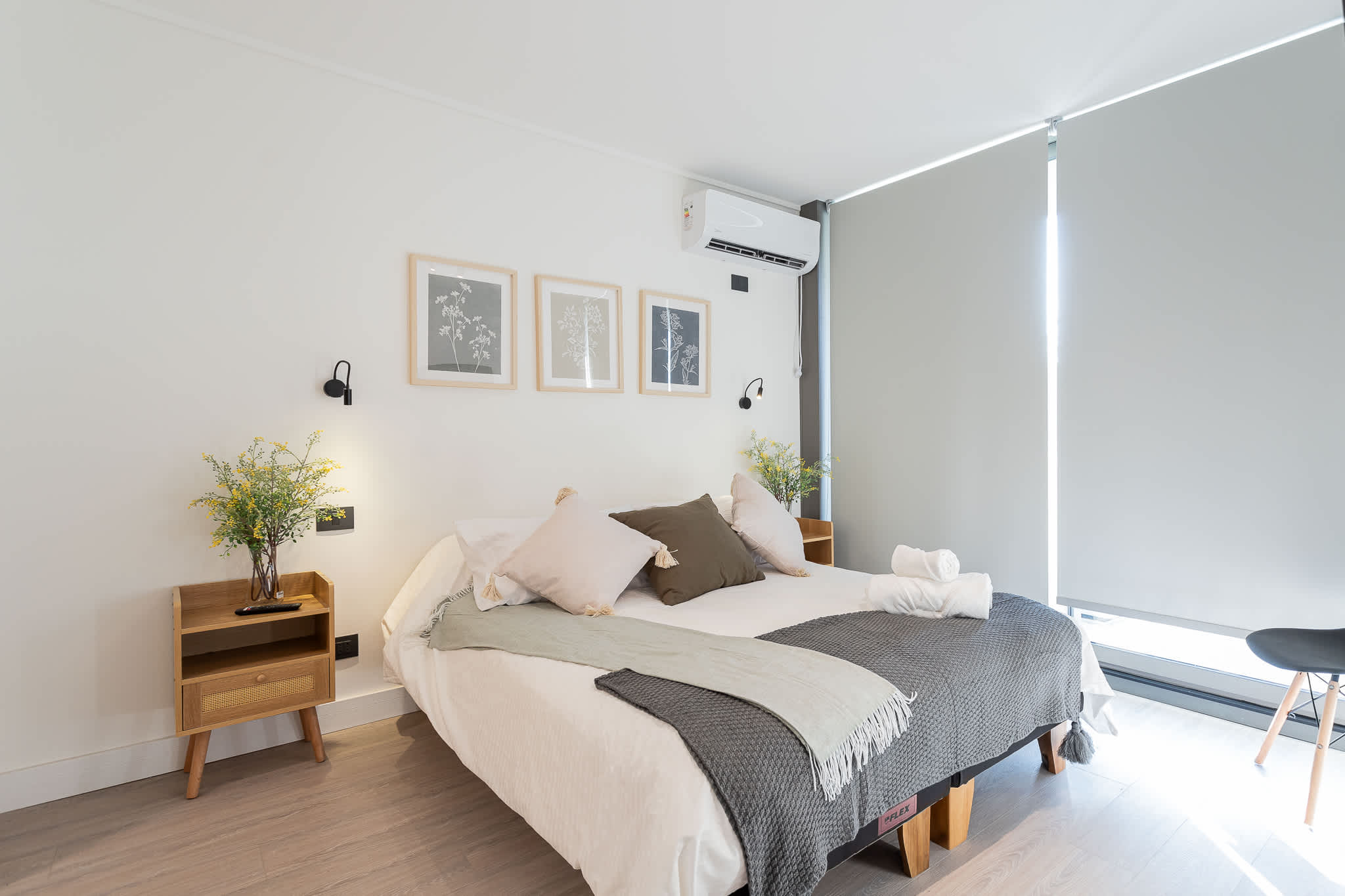 Relax in this cozy bedroom featuring a large bed, stylish decor, and plenty of natural light for a refreshing stay.