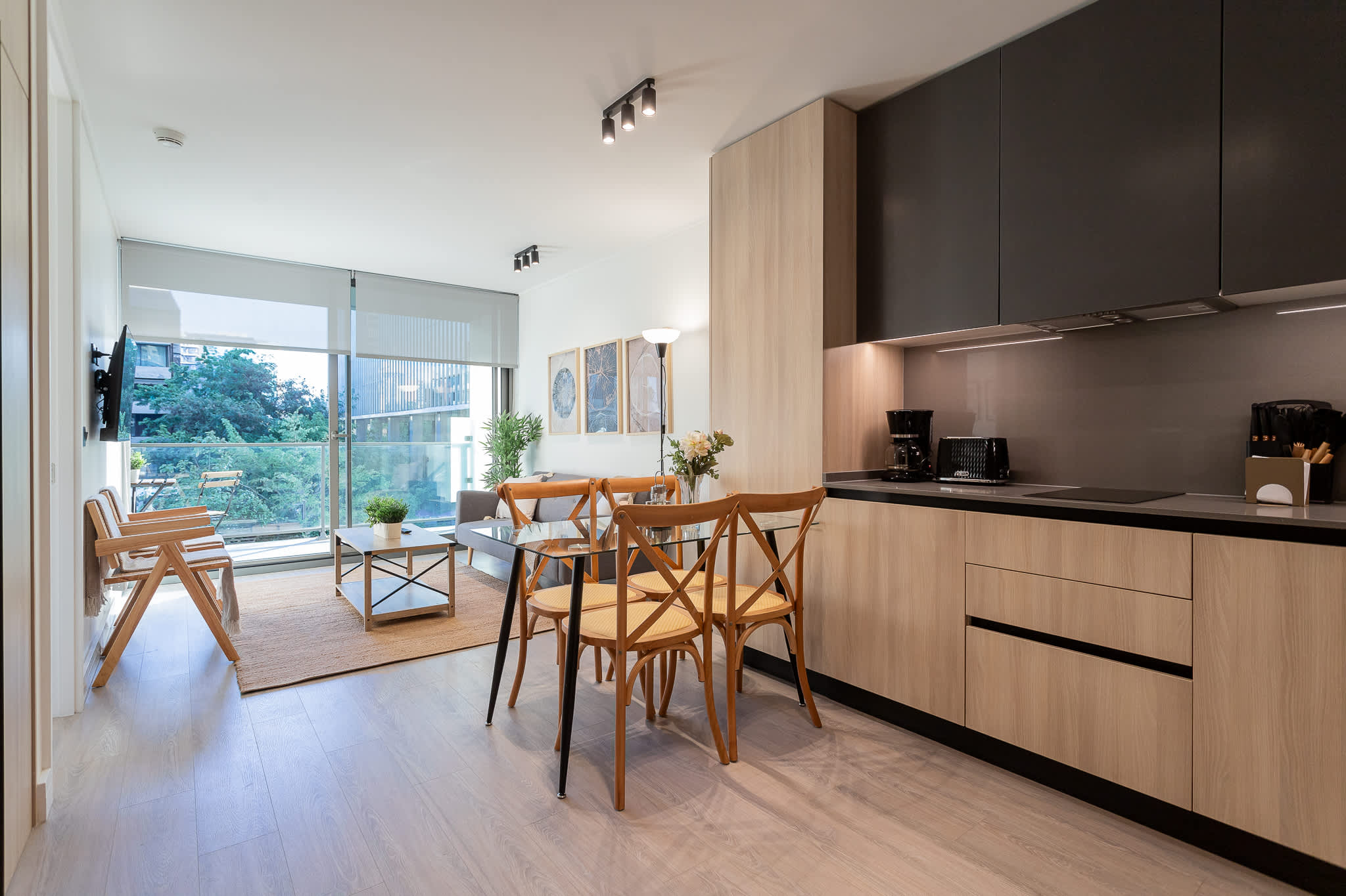 Bright and modern living space with a stylish kitchen and dining area, perfect for relaxing and enjoying the view.