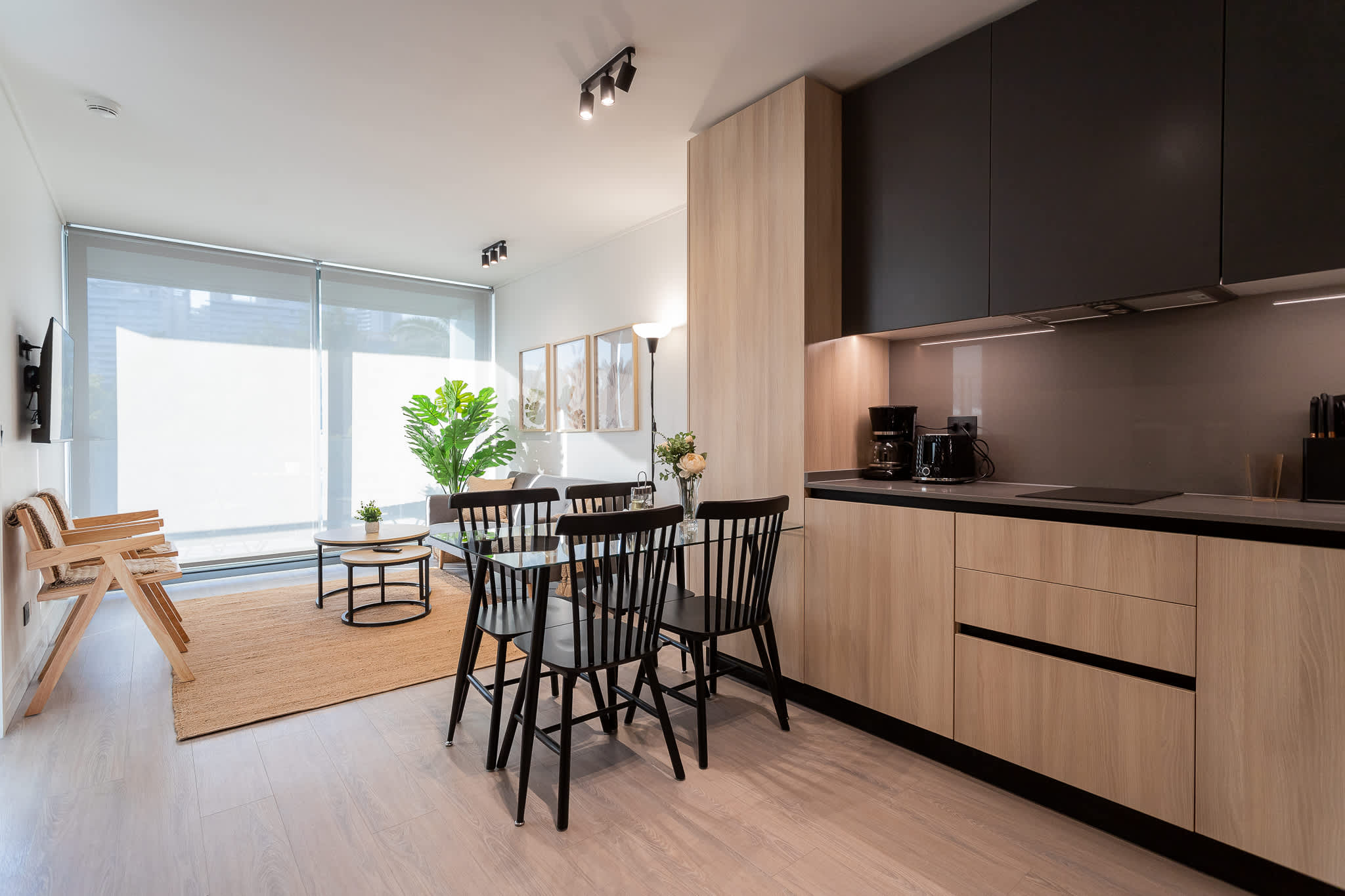 Experience modern comfort in this stylish living space, featuring a sleek kitchen, cozy dining area, and abundant natural light.