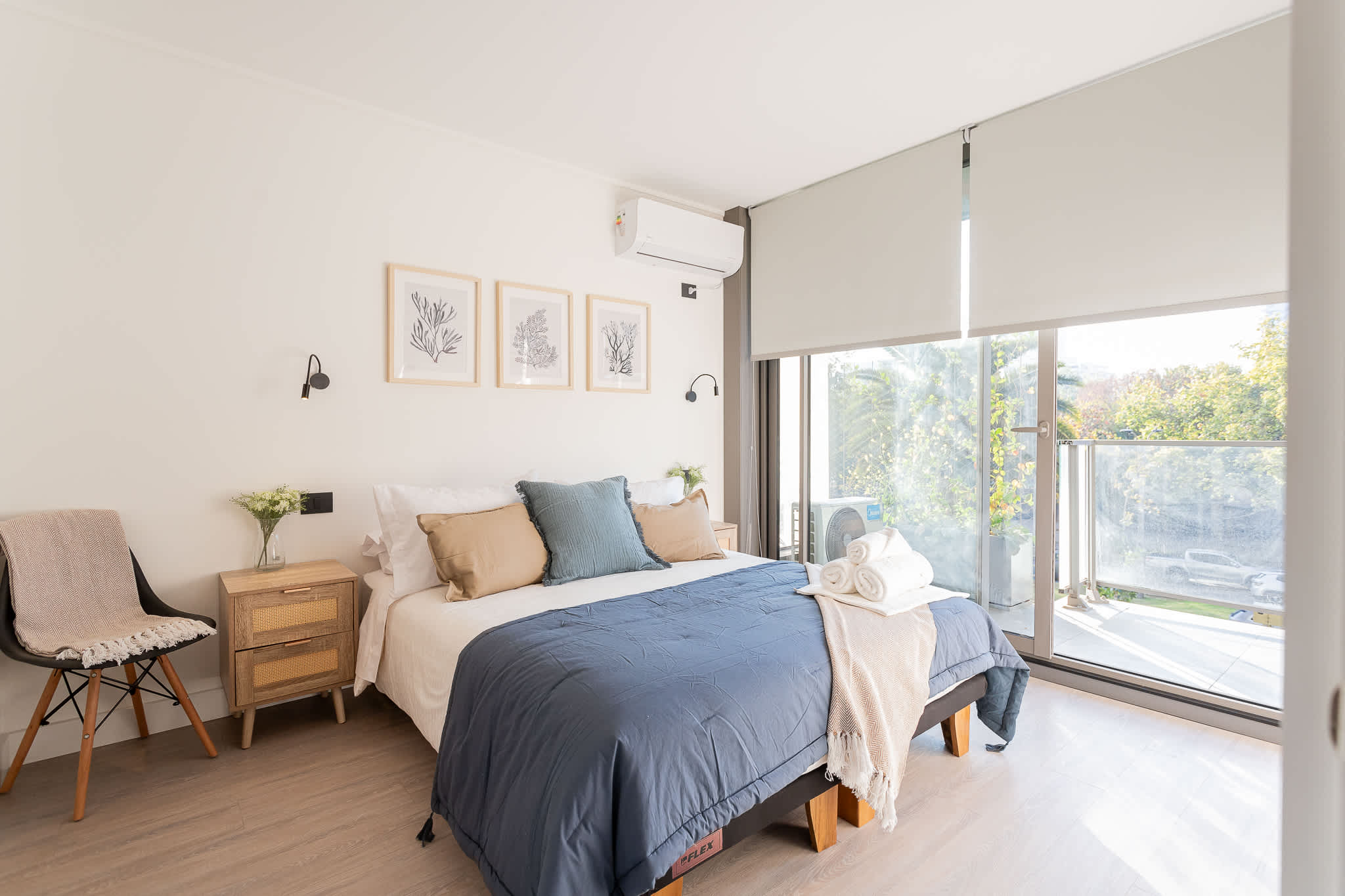 Relax in this serene bedroom featuring a cozy bed, stylish decor, and natural light streaming in from the balcony.