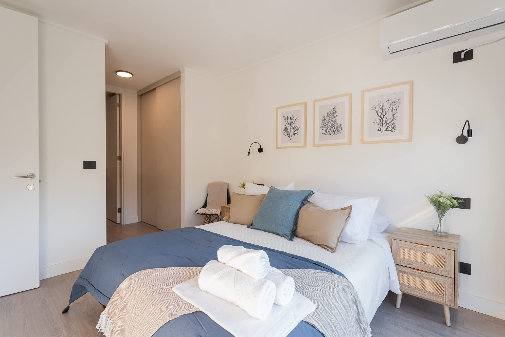 Relax in this serene bedroom featuring a cozy bed, stylish decor, and modern amenities for a restful stay.