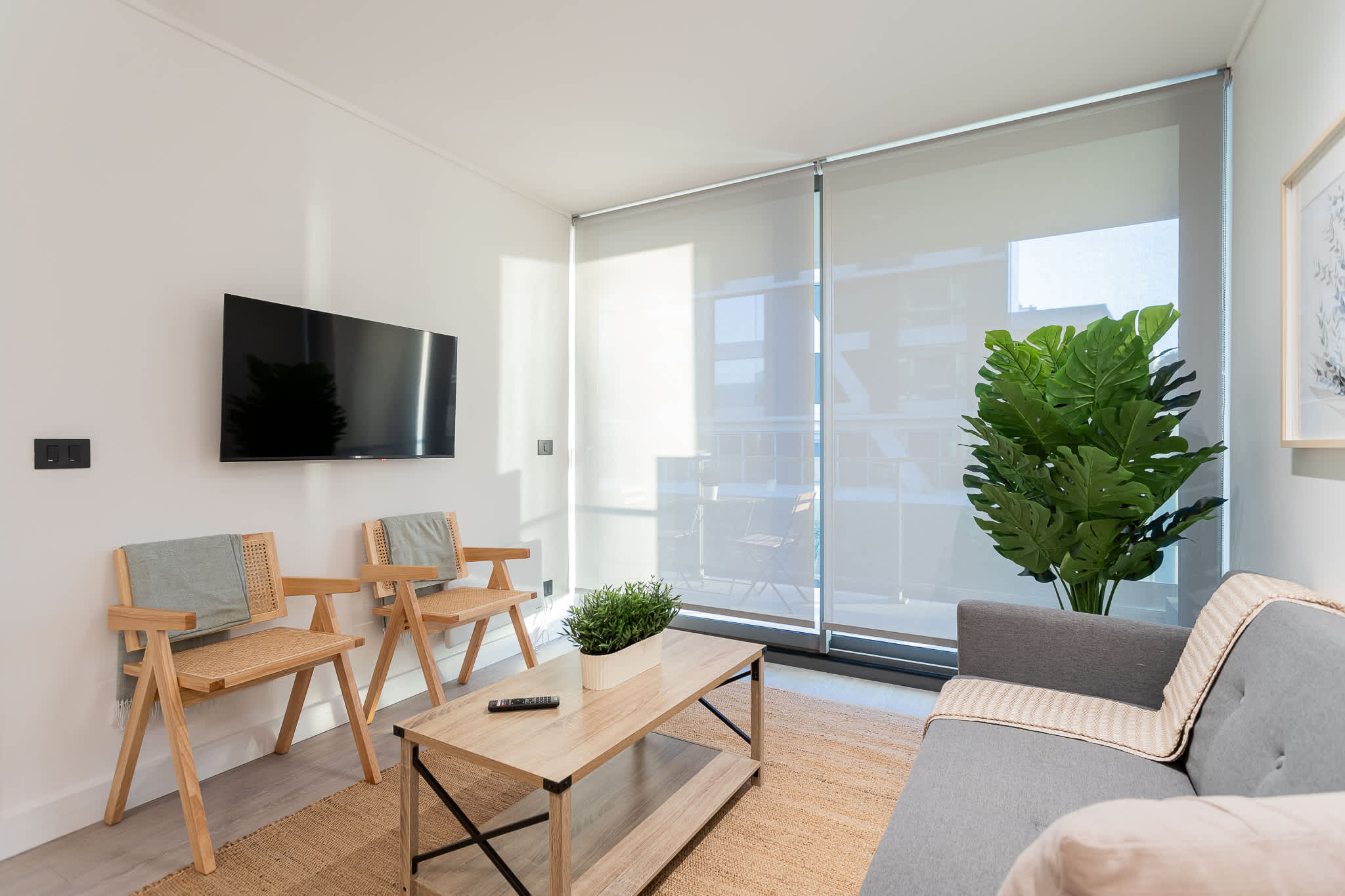 Bright and airy living room with modern furnishings and large windows, perfect for relaxation and enjoying the view.