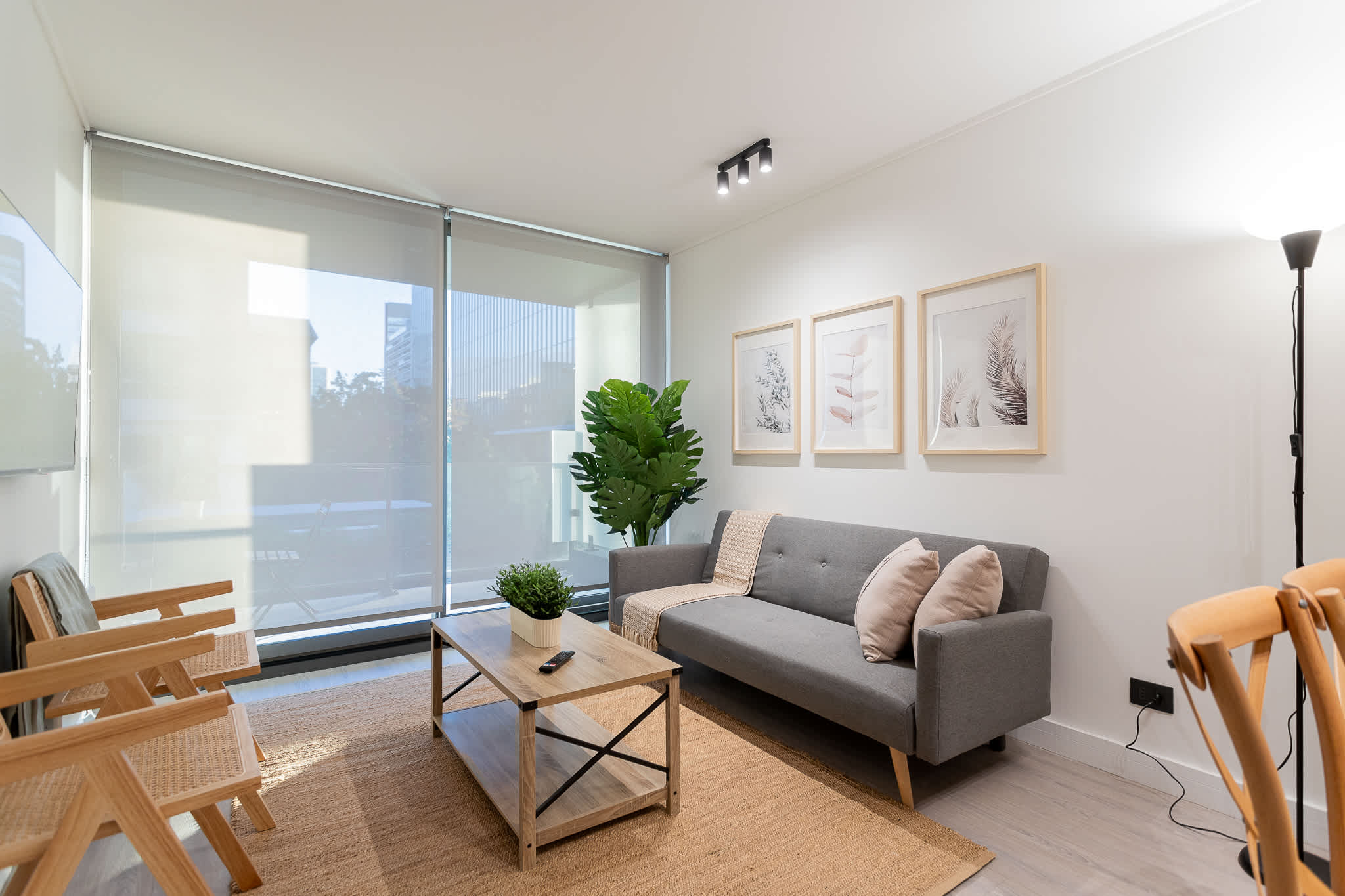 Relax in this modern living room filled with natural light, featuring stylish decor and a cozy atmosphere for your perfect getaway.