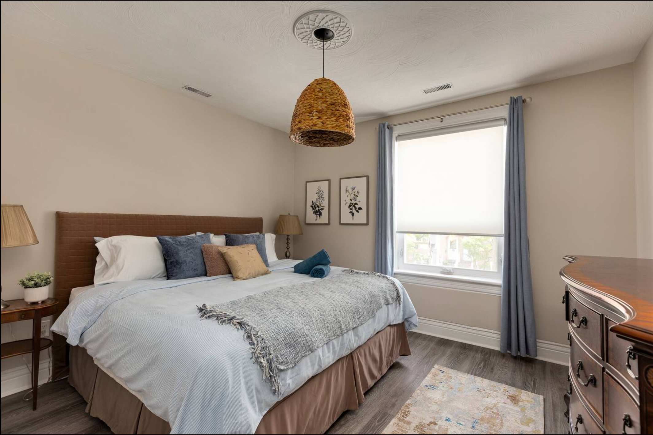 King bedroom with fresh linens and natural light