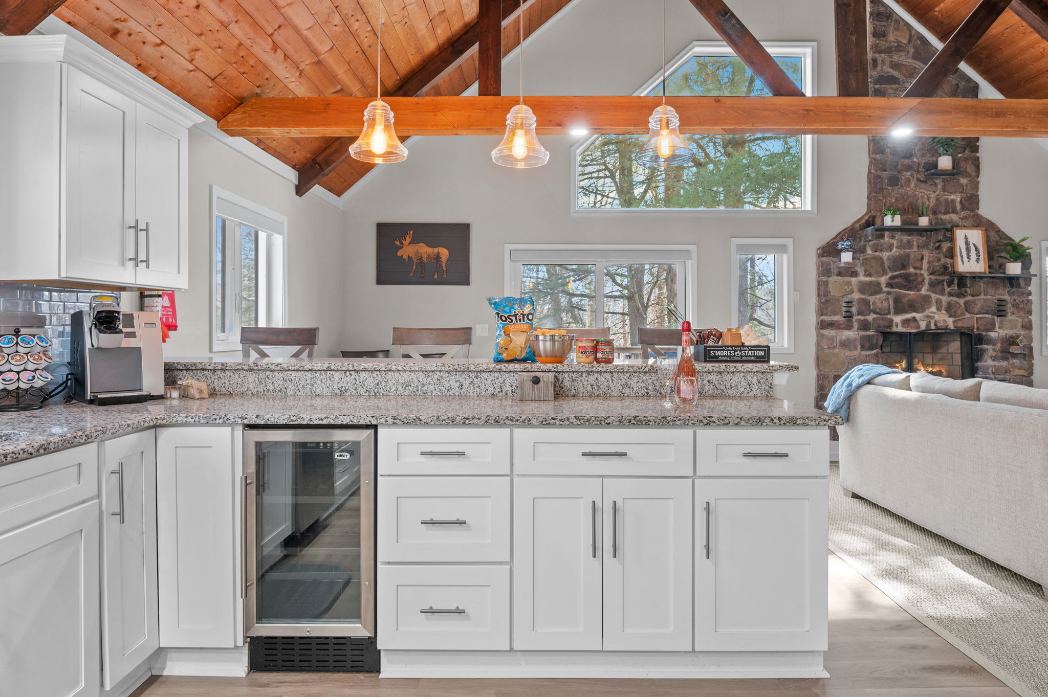 Bright and Functional
Sleek white cabinetry, exposed beams, and warm wood details bring together beauty and utility in this well-stocked kitchen.