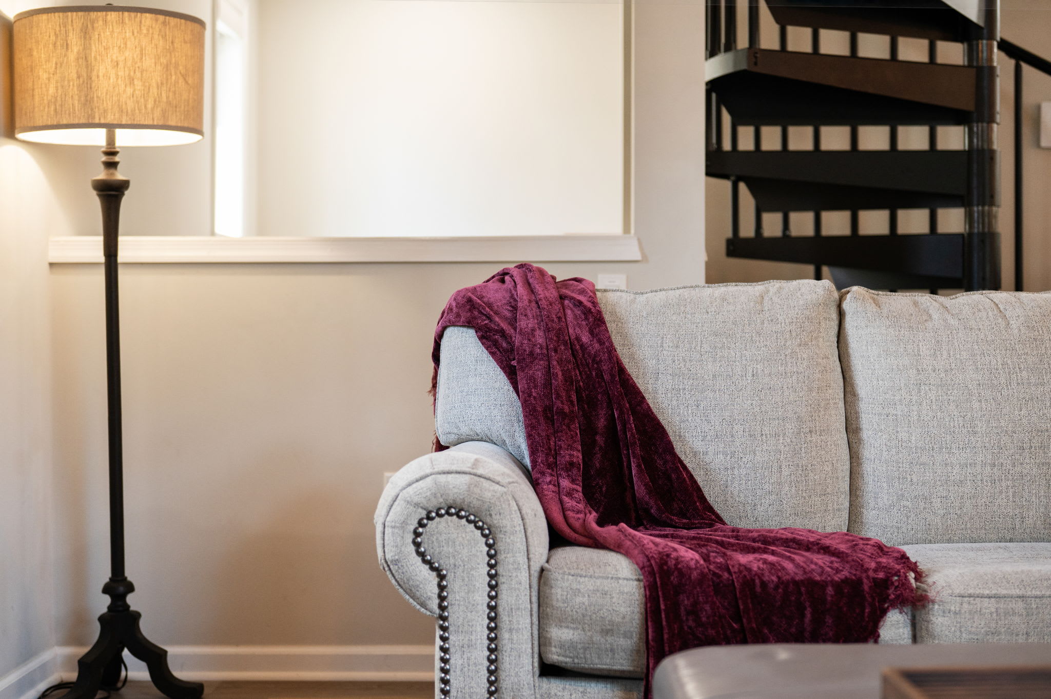 Cozy Nook by the Stairs
A quiet reading corner with a comfy chair and throw blanket, tucked right next to the spiral staircase.