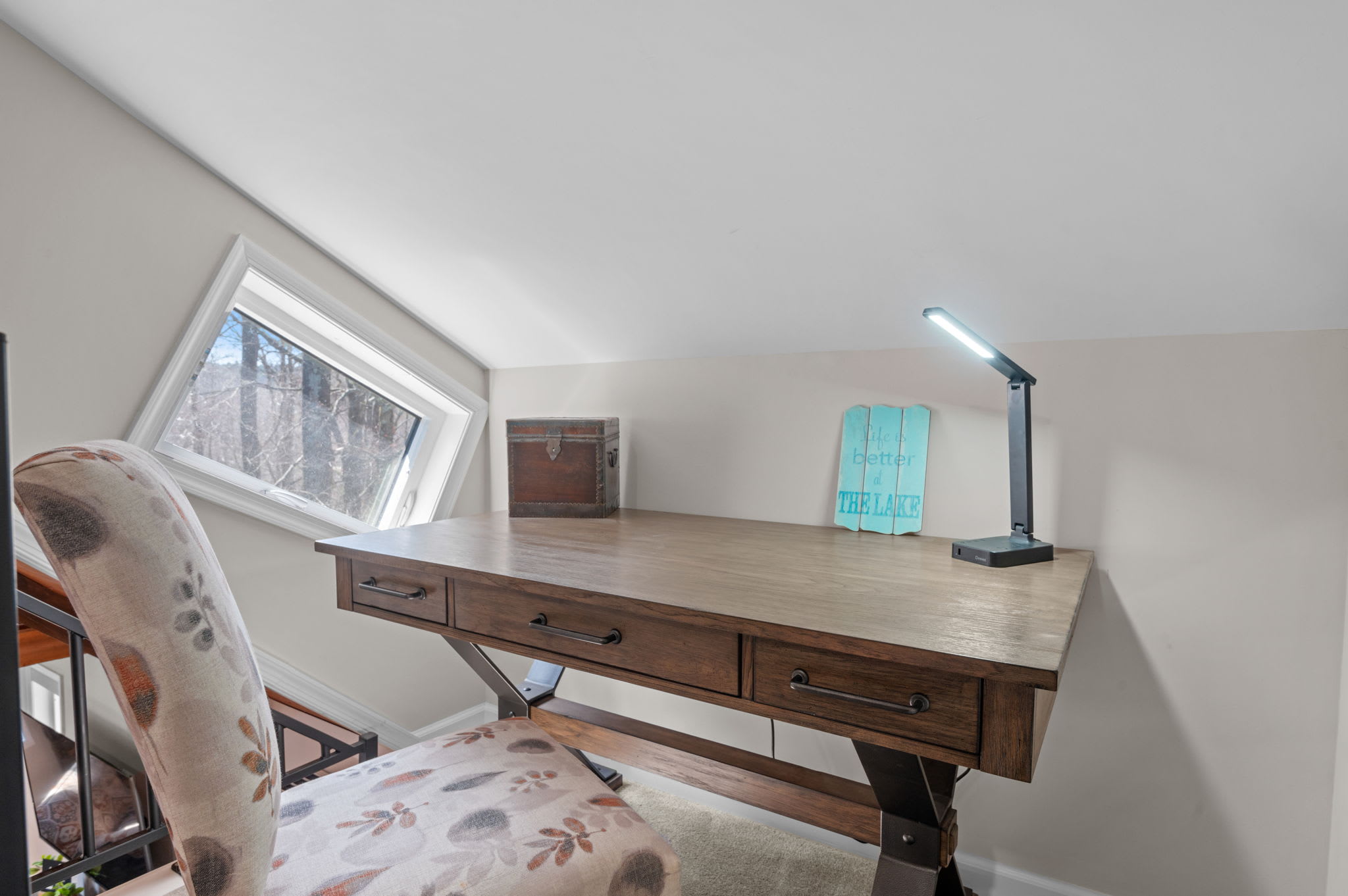 Quiet Workspace with a View
Tucked under the eaves, this charming desk setup offers a peaceful spot to focus or reflect.