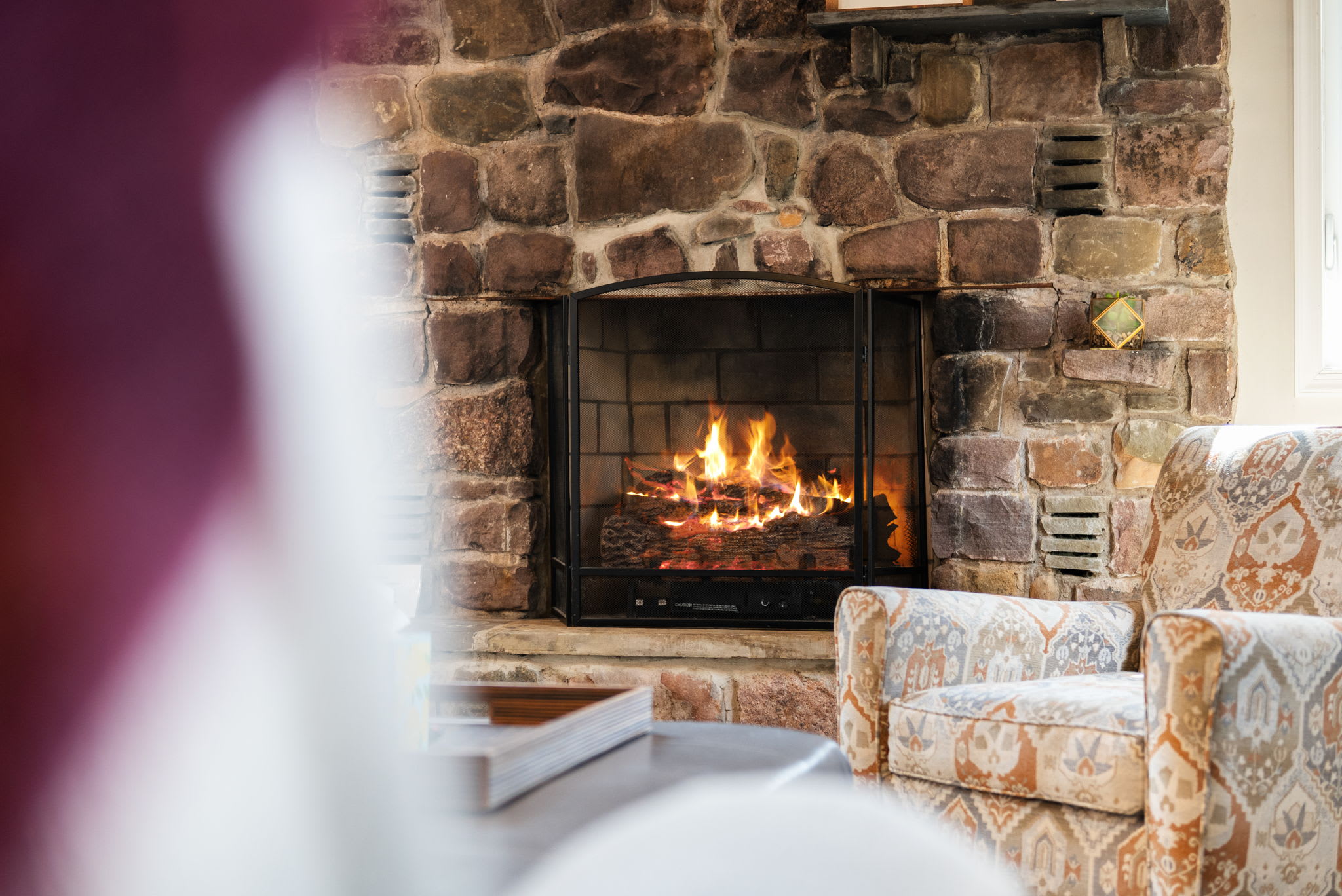 Warm Glow and Rustic Stone
The crackling fireplace brings comfort and charm to every evening, making it the ultimate unwind zone.