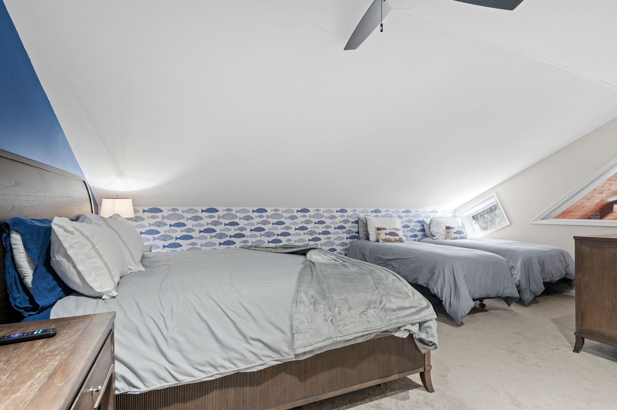 Charming Loft-Style Room
Tucked beneath angled ceilings, this spacious bedroom features three beds and a cozy, tucked-away feel.