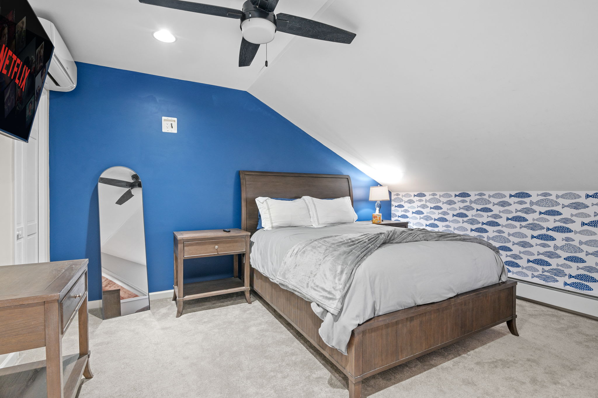 Blue and Breezy Energy
A pop of color and ceiling fan overhead make this room equal parts playful and relaxing.