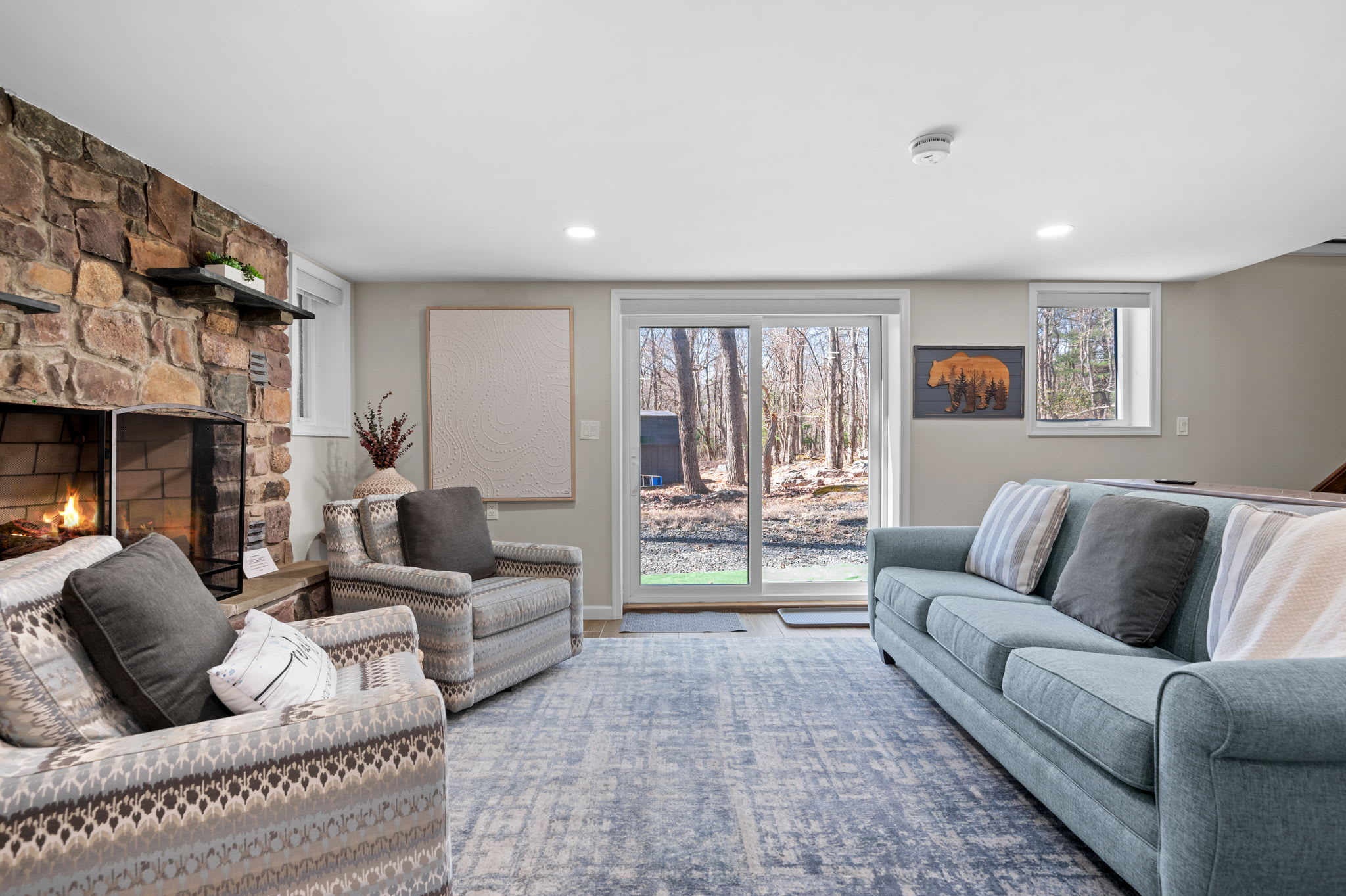 Lower-Level Lounge
Cozy up by the stone fireplace or relax on the plush seating with a view of the trees just outside.