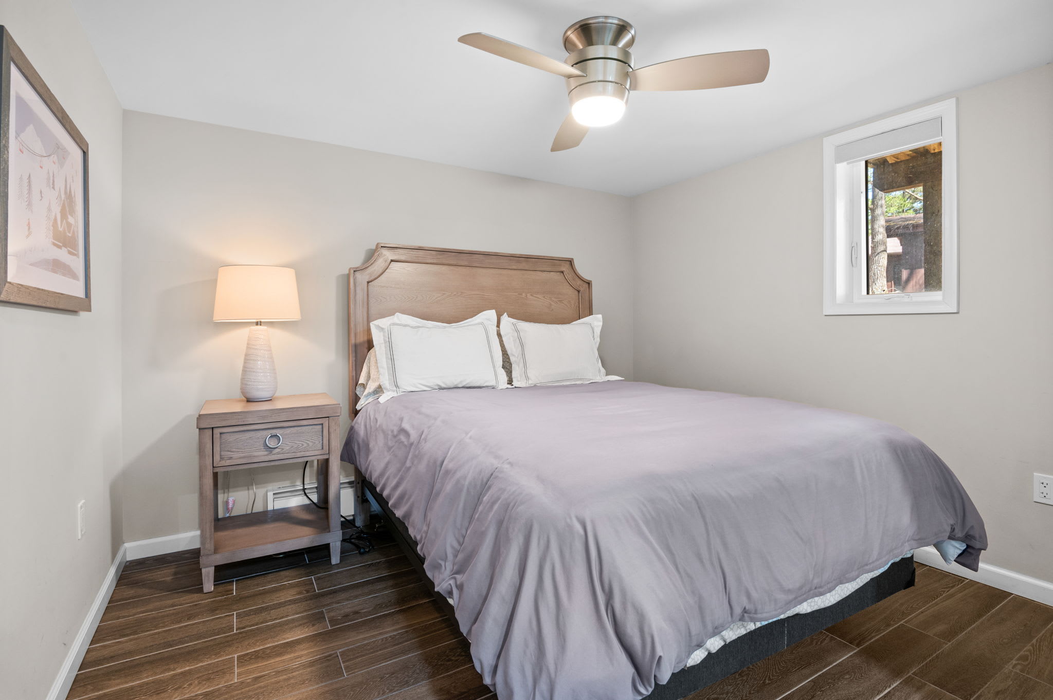 Soft Tones and Natural Light
A peaceful second bedroom with soft bedding, ceiling fan, and subtle decor for a welcoming feel.