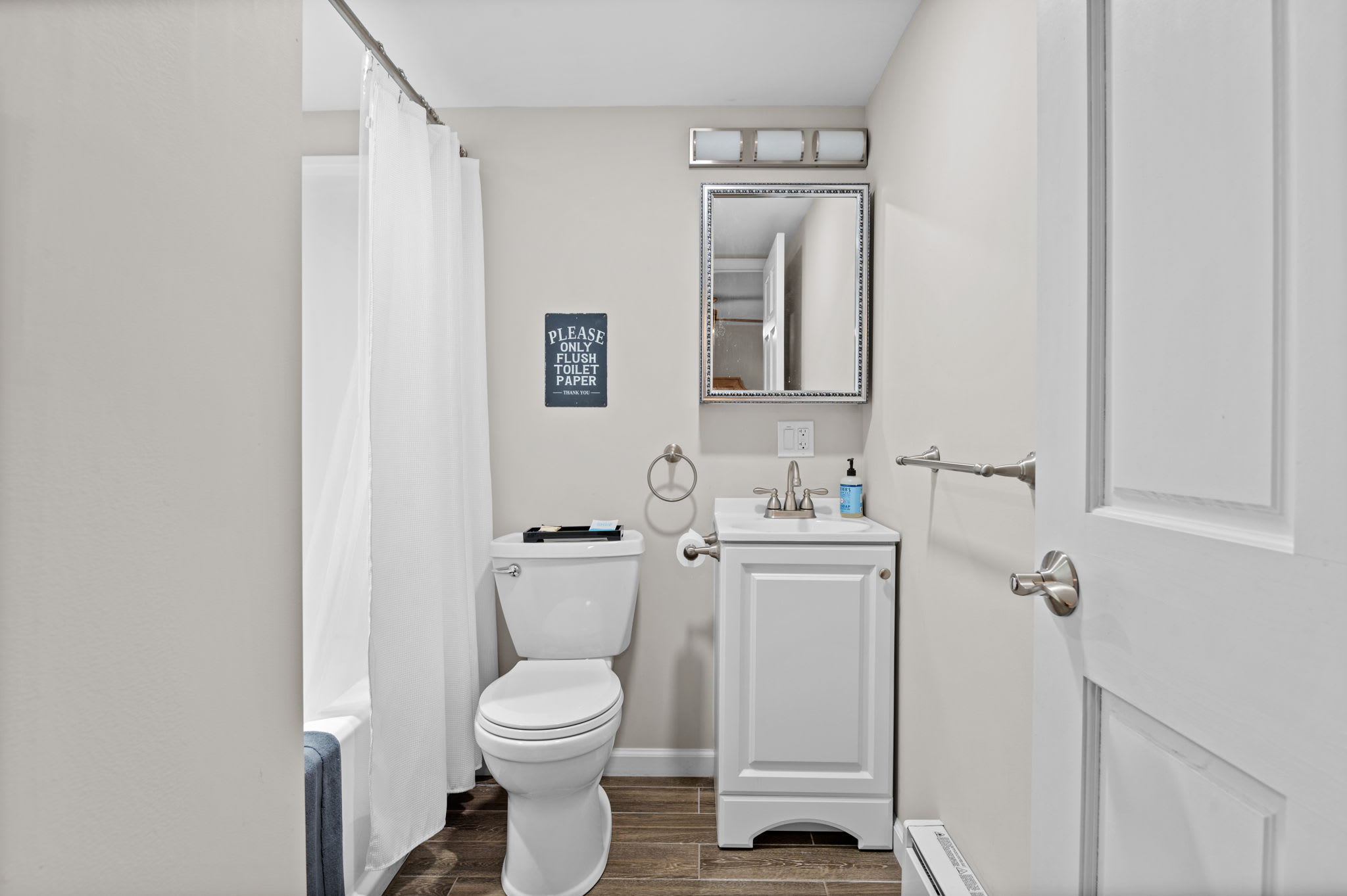 Bright and Tidy Bathroom
Complete with a vanity mirror, open shelving, and everything you need for a fresh start or a wind-down shower.
