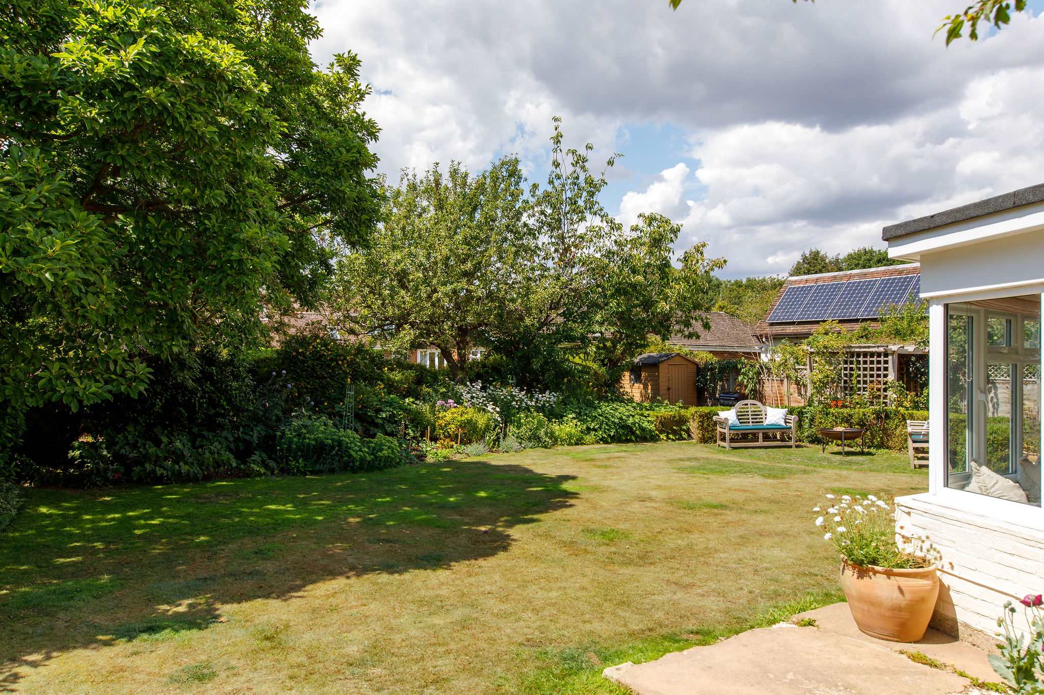 Beautifully cared for back garden, stocked with various plants and flowers