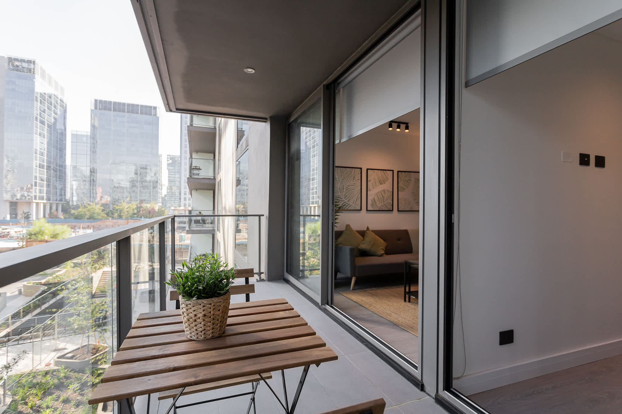 Enjoy a cozy balcony with a view of the city skyline, perfect for relaxing moments in this modern urban retreat.
