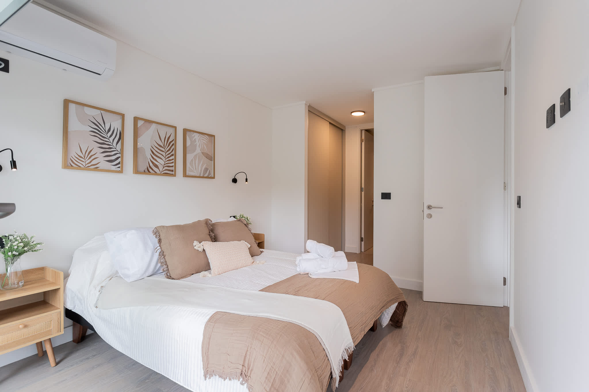 Relax in this serene bedroom featuring modern decor and cozy bedding, perfect for a restful getaway.