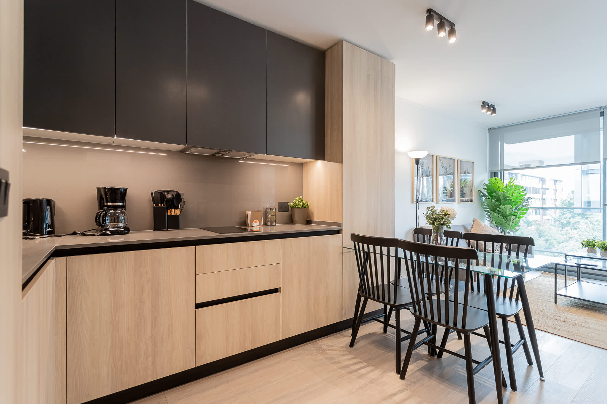 Experience modern living in this stylish kitchen, featuring sleek cabinetry and a bright dining area perfect for gatherings.