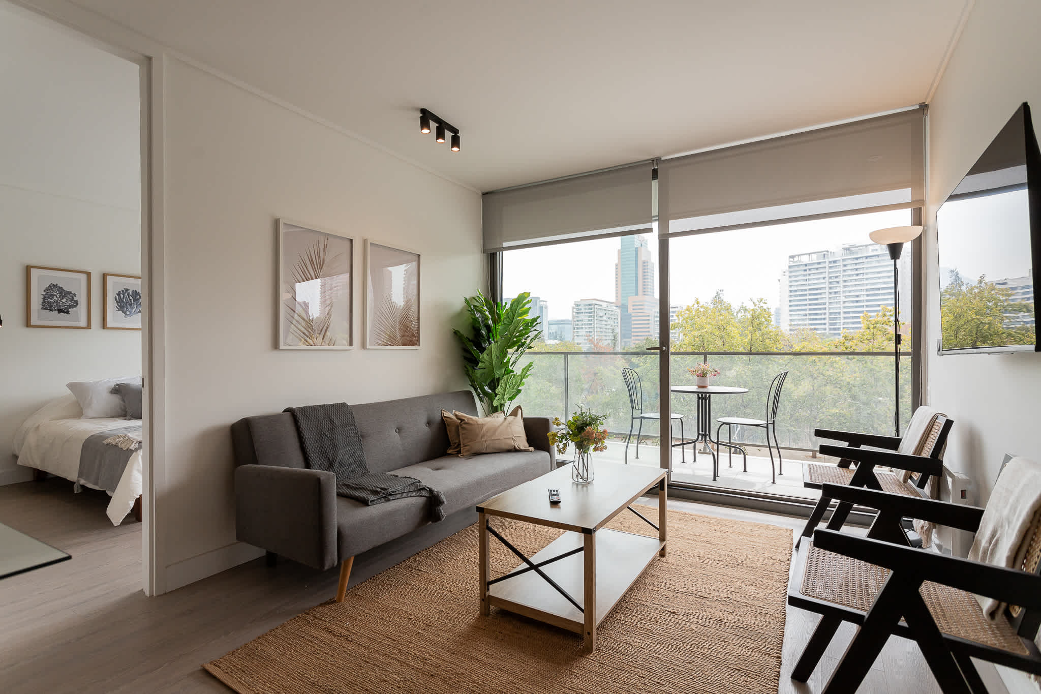 Bright and modern living space with stunning city views, perfect for relaxation and enjoying the vibrant surroundings.