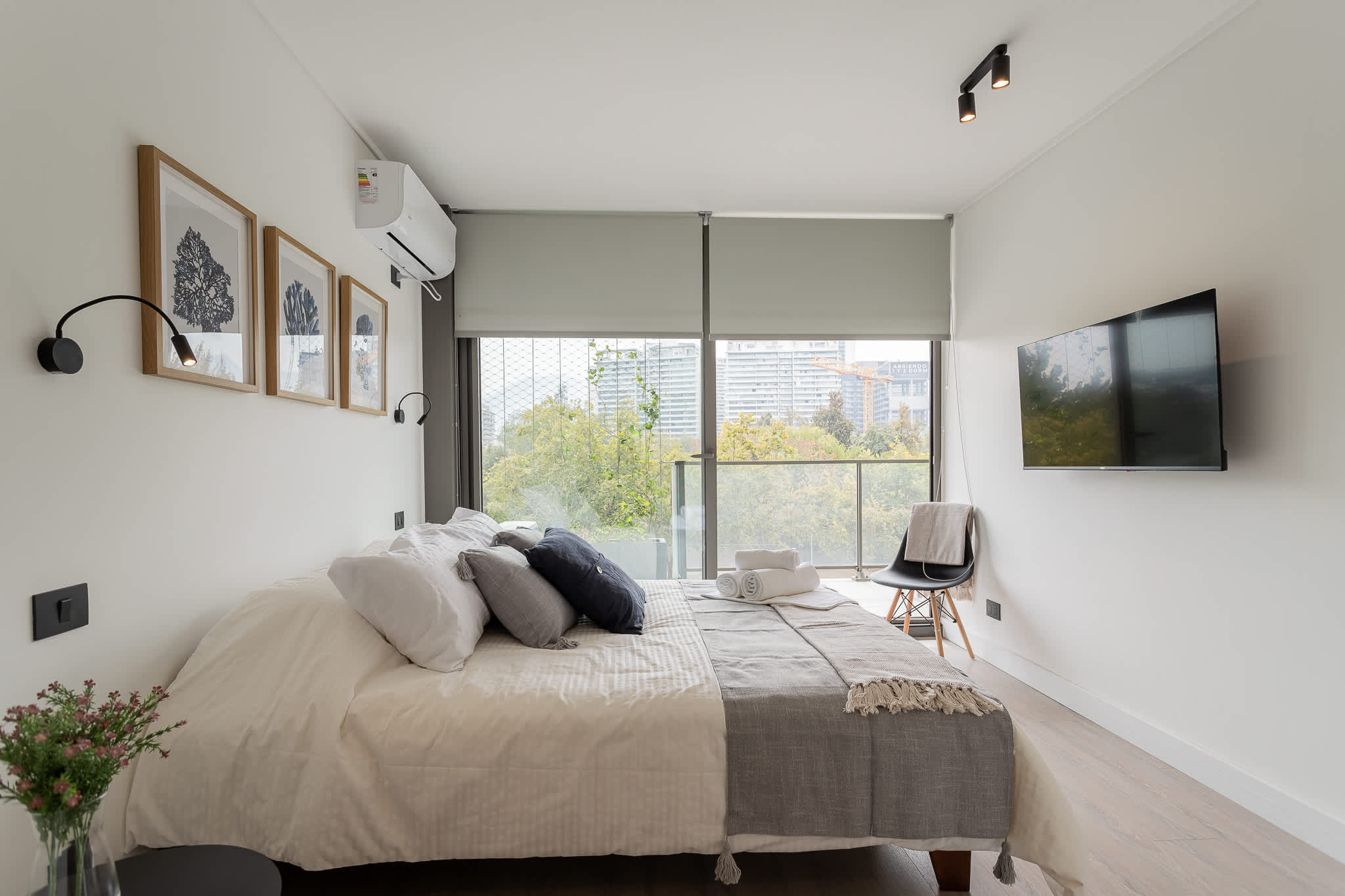 Stylish bedroom with a cozy vibe, featuring a queen bed, modern decor, and a lovely view. Perfect for a relaxing stay!