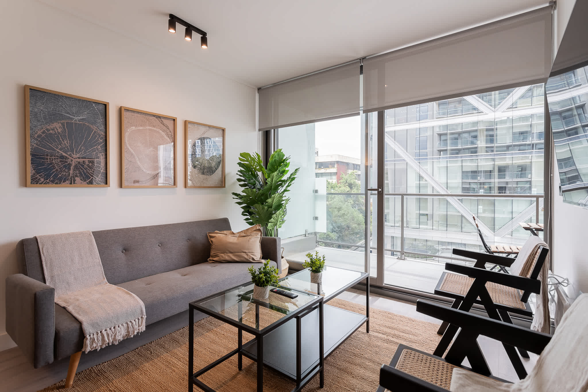 Bright and modern living room with stylish decor and balcony access, perfect for relaxing after a day of exploring.