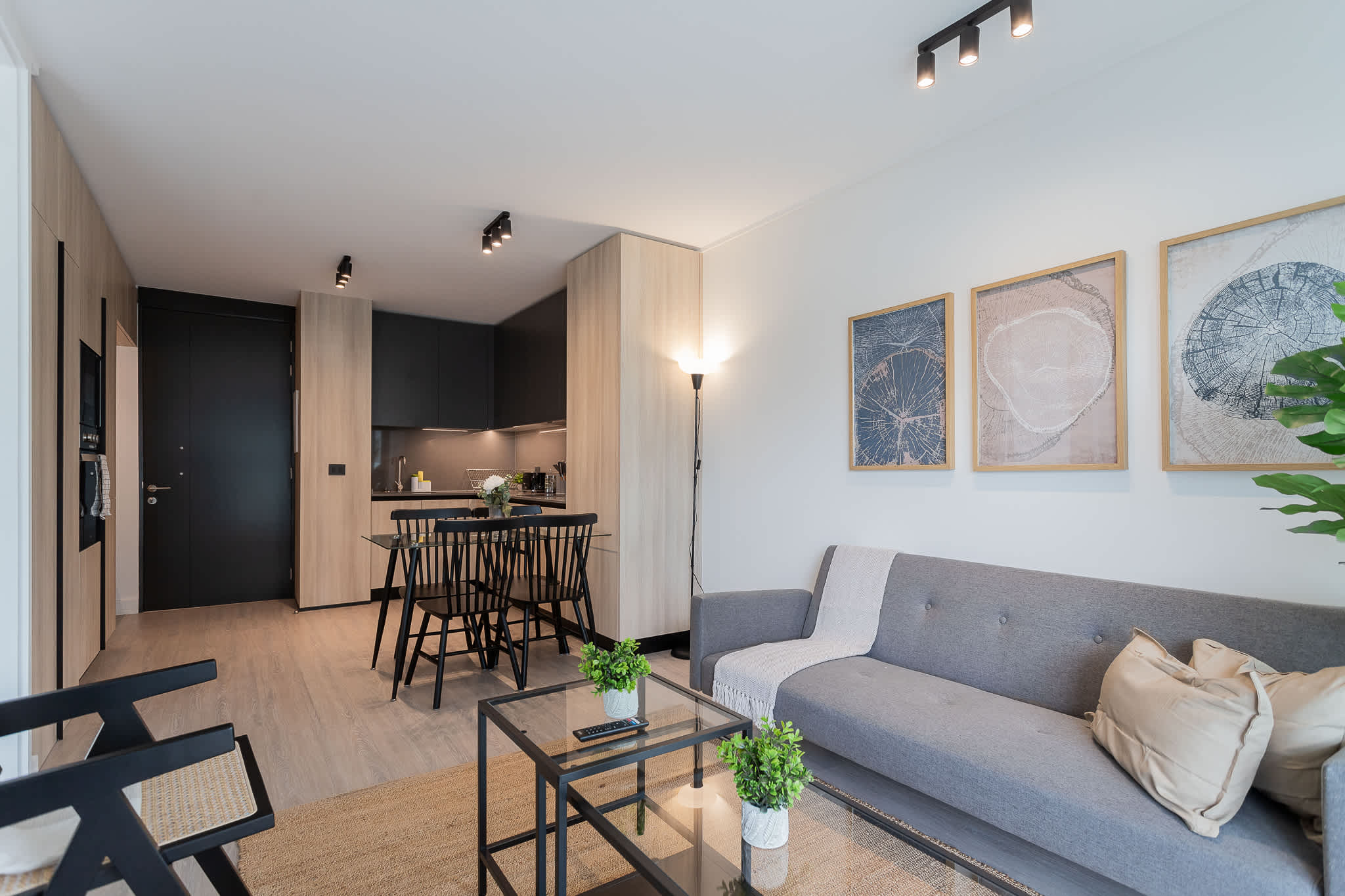 Experience modern comfort in this stylish living space, featuring a cozy sofa, dining area, and a sleek kitchen—perfect for your getaway!