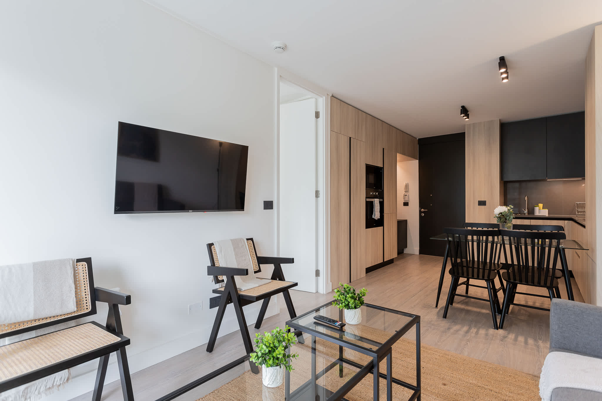 Experience modern comfort in this stylish living space, featuring a cozy dining area and sleek kitchenette, perfect for your getaway!