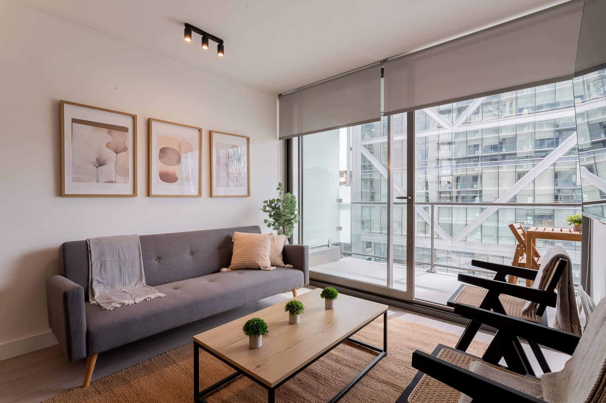 Bright and modern living space with stylish decor and a cozy balcony, perfect for relaxation and enjoying city views.