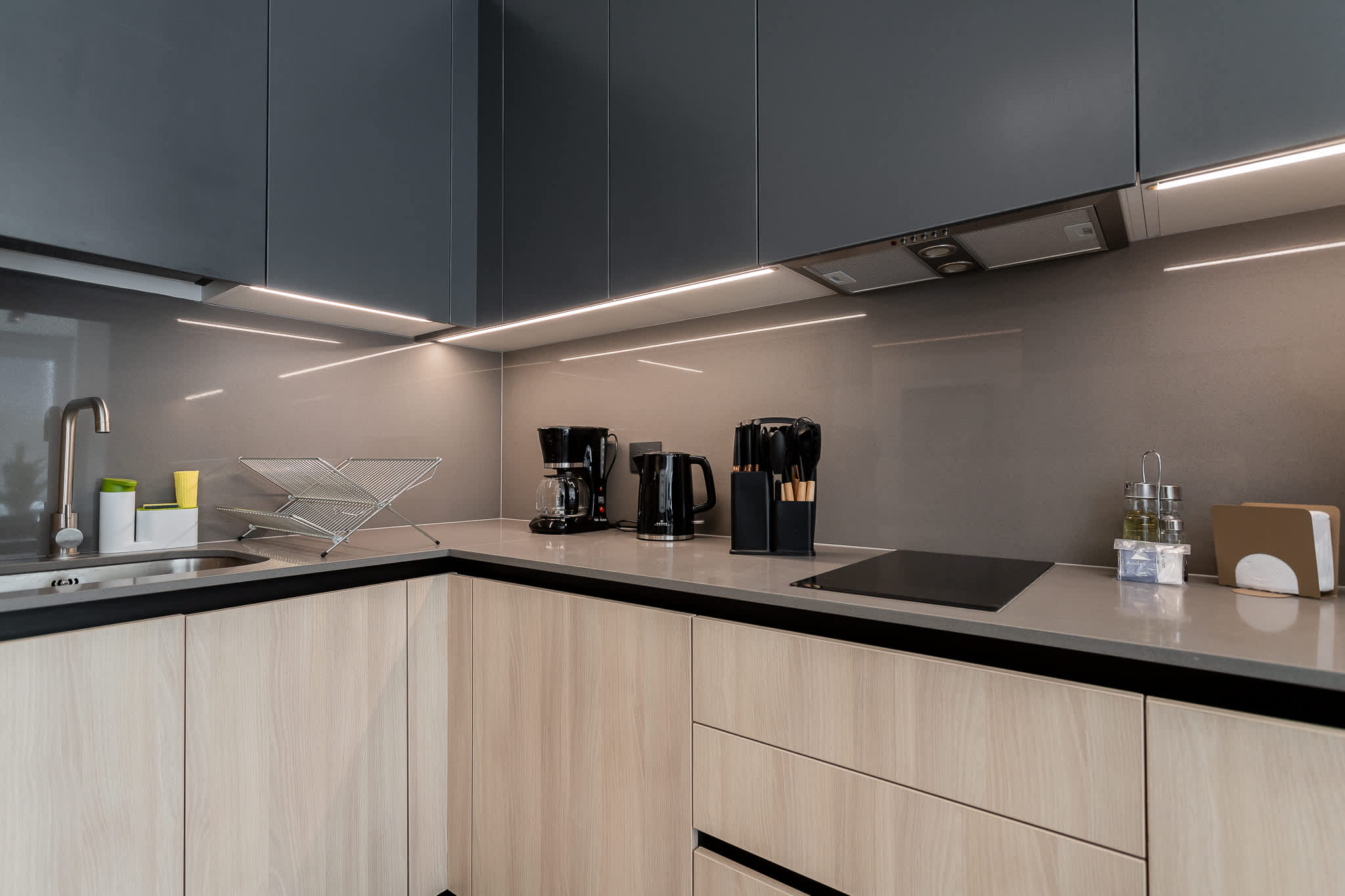 Sleek kitchen with modern appliances and stylish finishes, perfect for culinary enthusiasts.