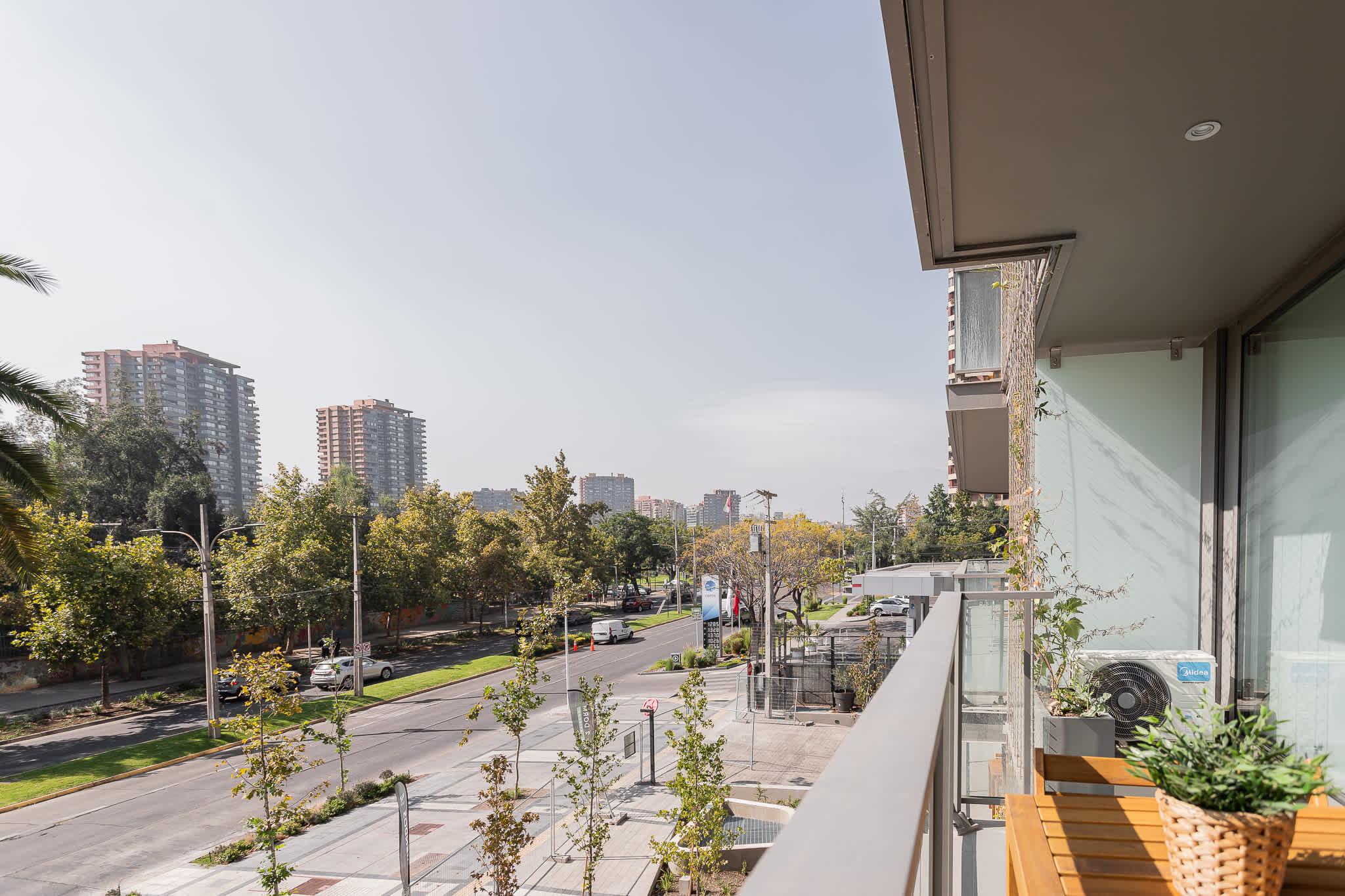 Relax on your private balcony with a stunning cityscape view, perfect for enjoying the vibrant urban life.