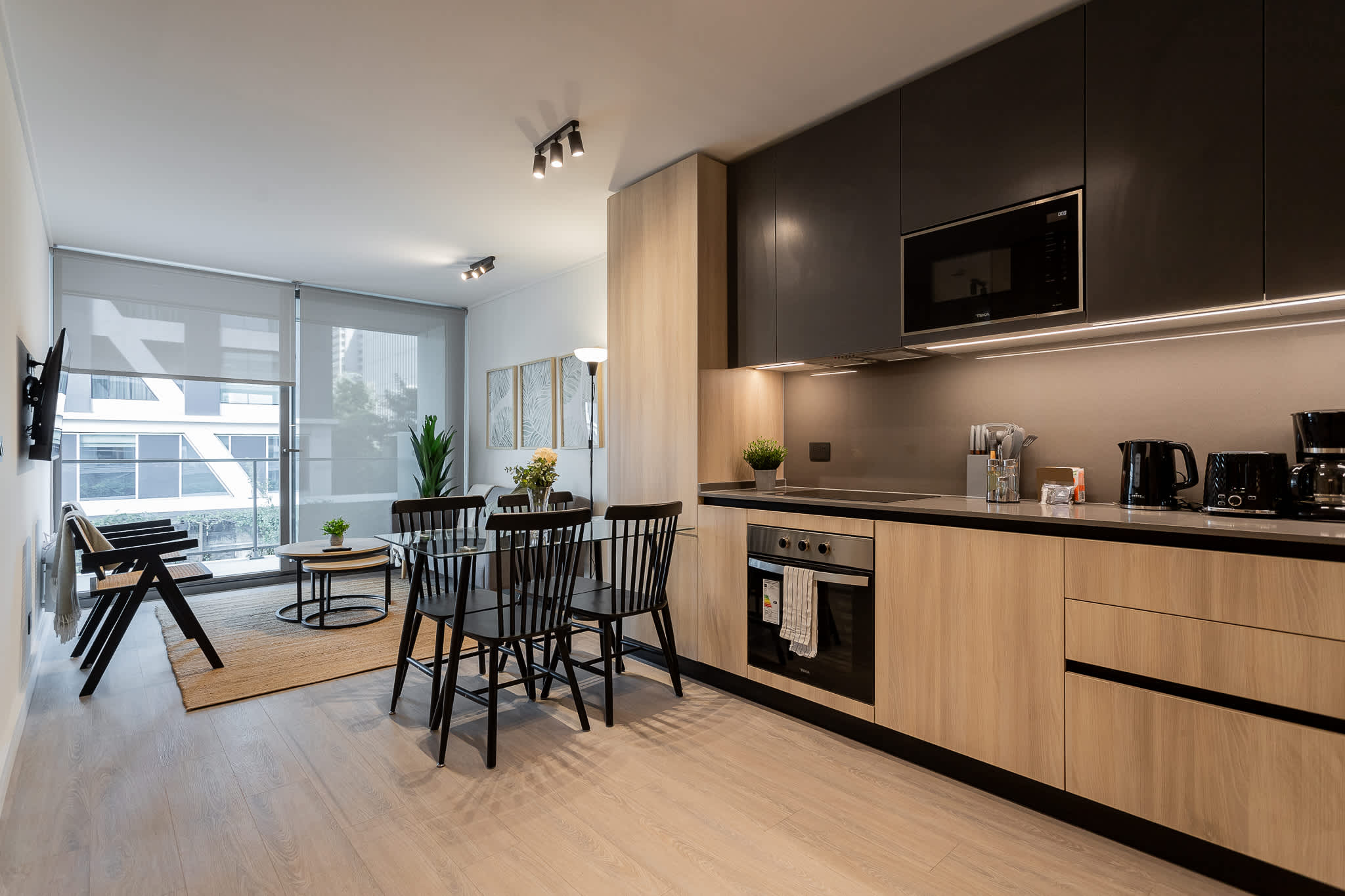 Experience modern living in this stylish kitchen, featuring sleek appliances and a bright dining area perfect for gatherings.