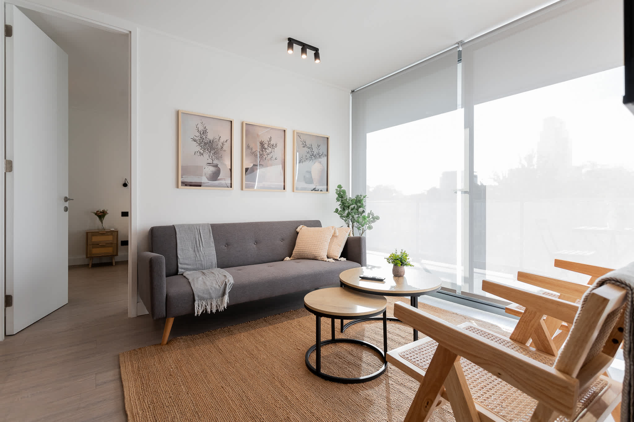 Bright and modern living space with stylish decor and cozy seating, perfect for relaxation and enjoying city views.