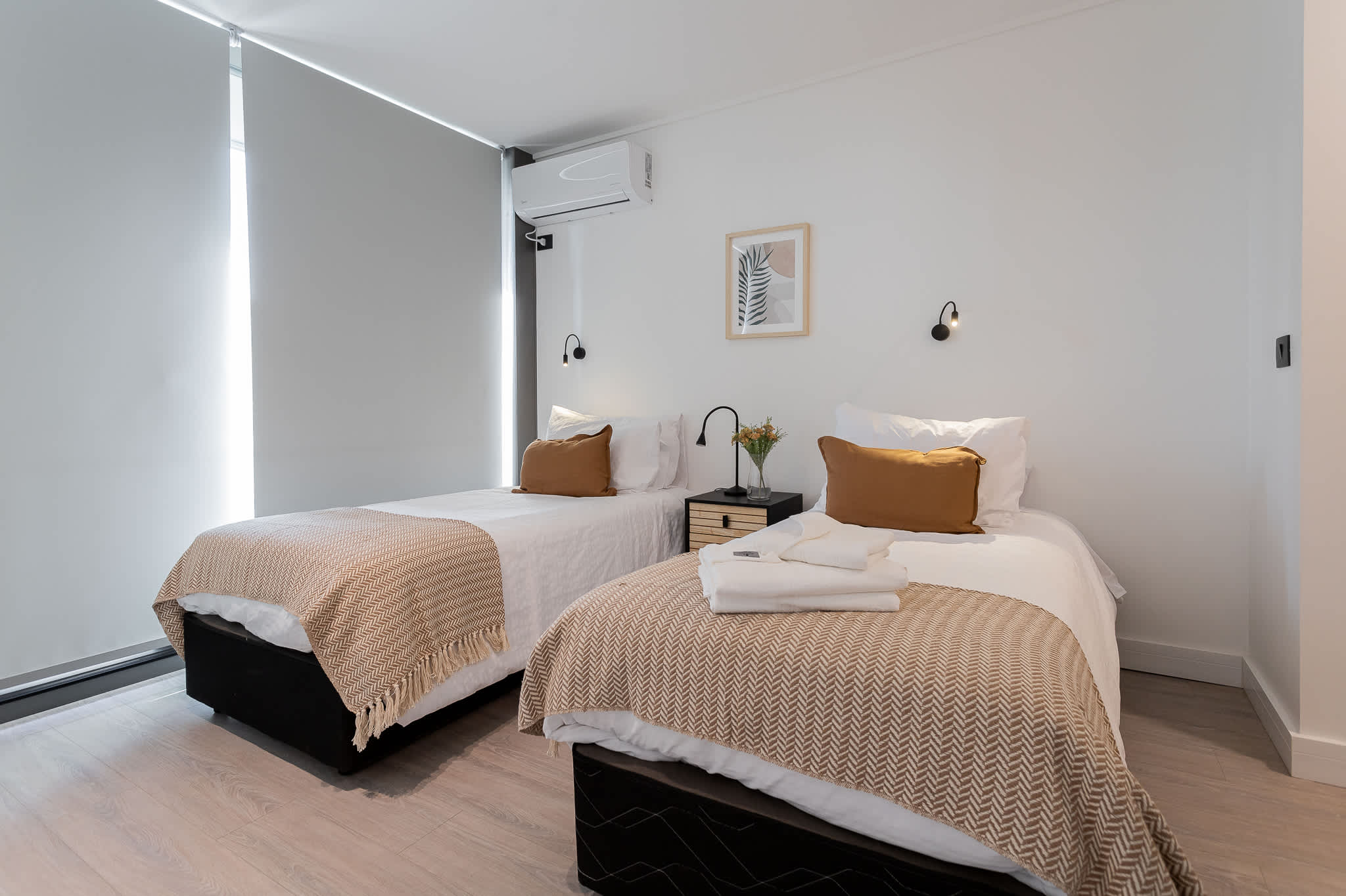 Cozy twin bedroom with modern decor, perfect for a restful stay in the heart of Chile.