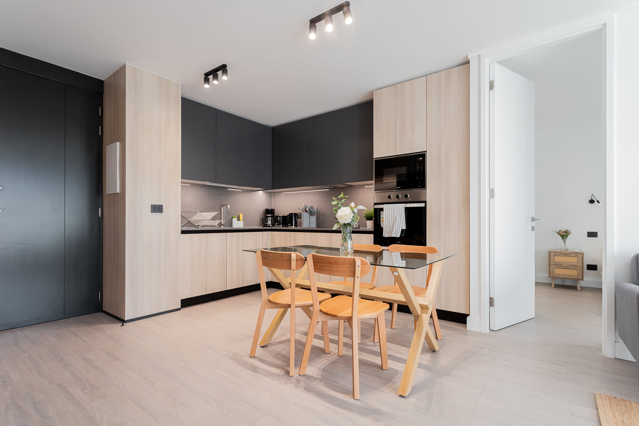 Sleek and modern kitchen with stylish dining area, perfect for enjoying meals in a cozy setting.
