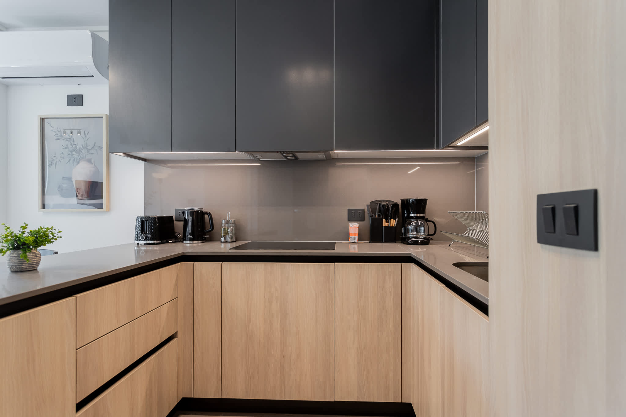 Sleek and modern kitchen with top-notch appliances, perfect for culinary enthusiasts seeking a stylish cooking space.