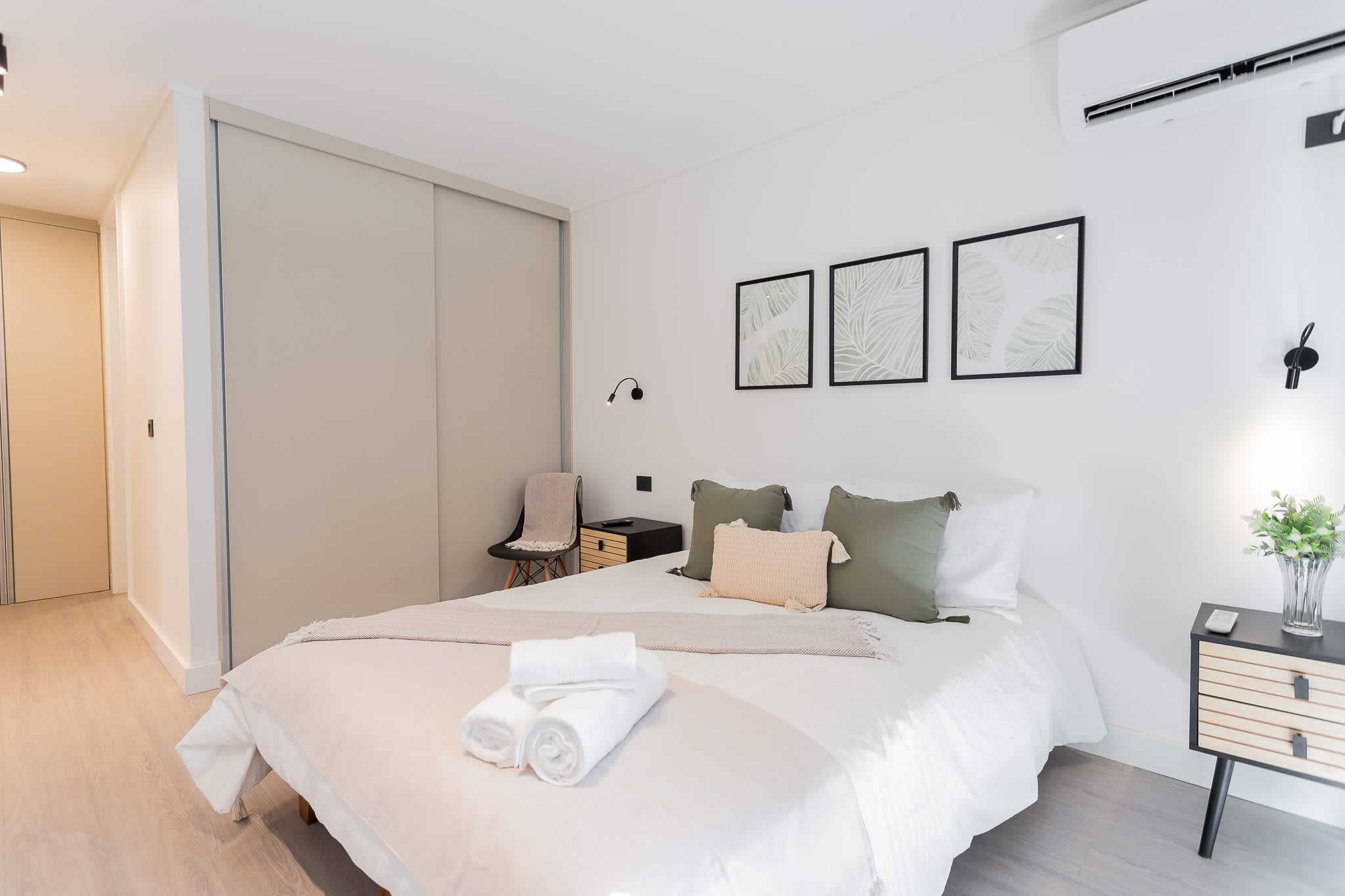 Relax in style in this chic bedroom with modern decor, cozy bedding, and air conditioning for your comfort.