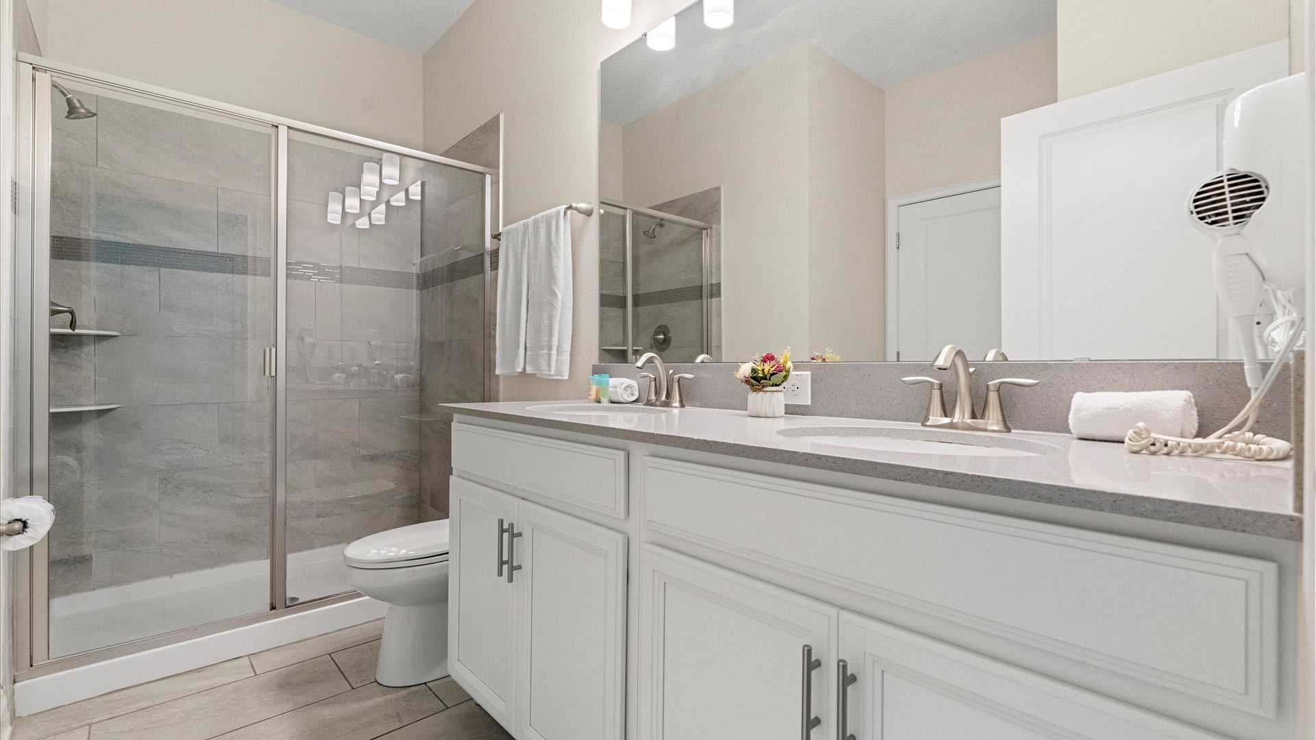 Spacious bathroom with double vanity and standing shower