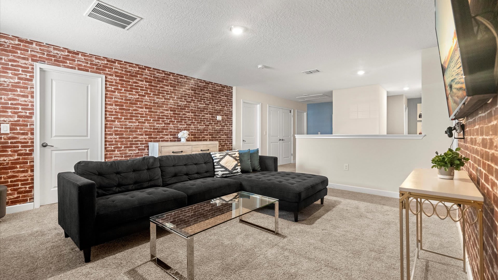 Upstairs TV Lounge with Industrial-style brick wall