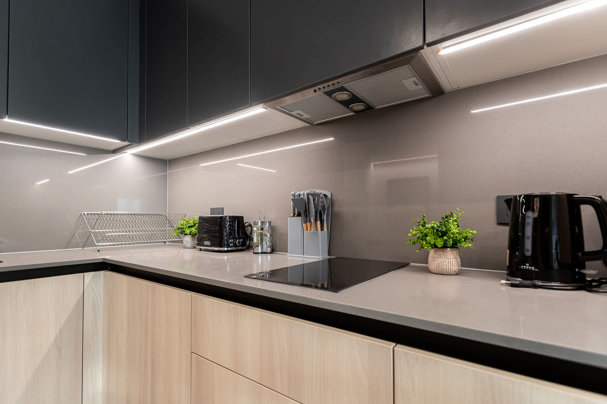 Experience culinary bliss in this modern kitchen, featuring sleek cabinetry and high-end appliances for your cooking adventures.